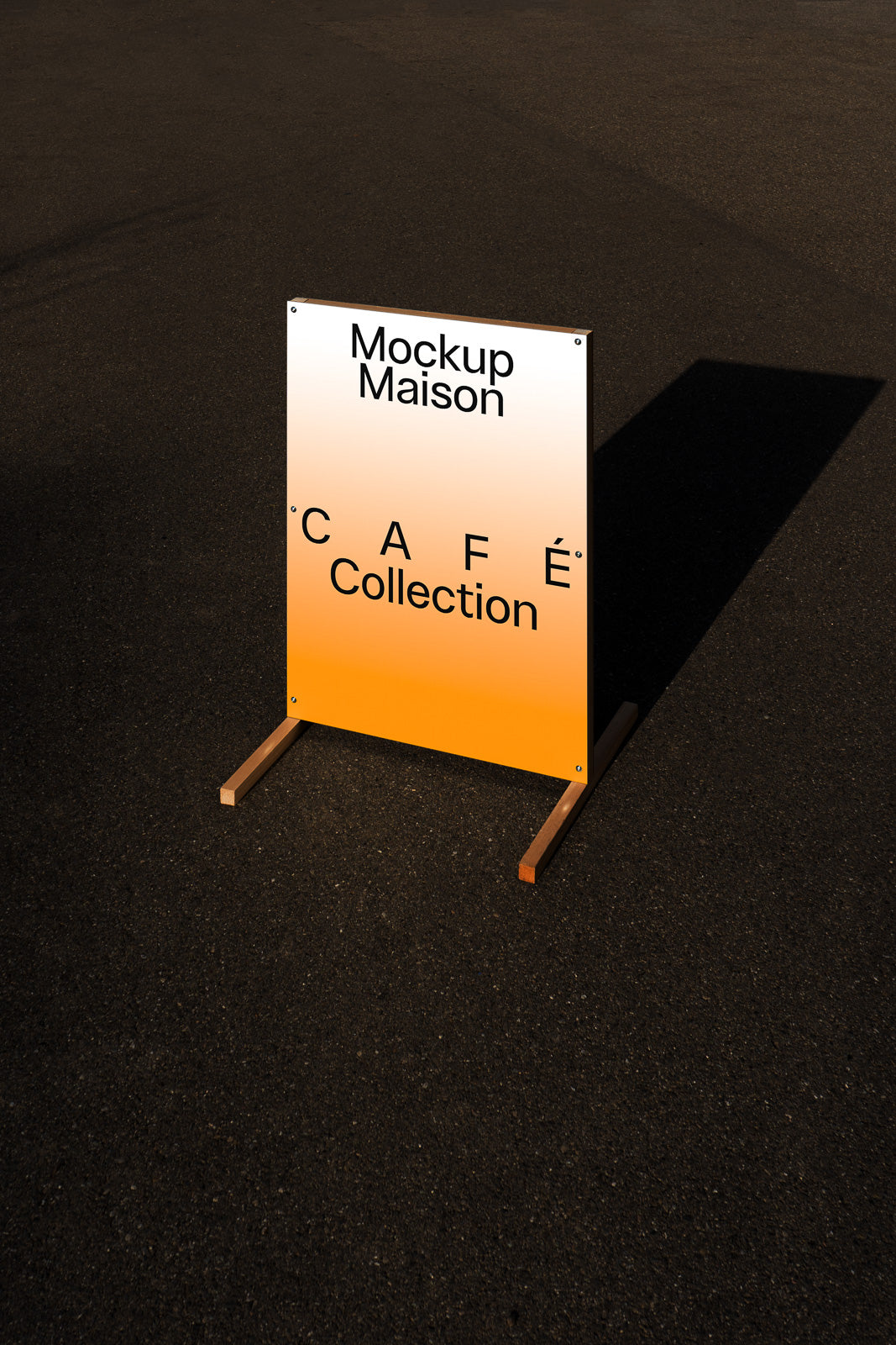 PSD mockup of a freestanding café sign on pavement, displaying "Mockup Maison Café Collection," with a gradient from white to orange.