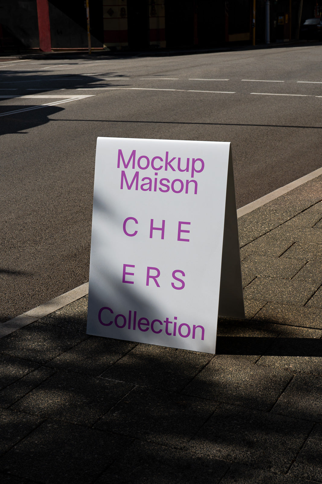 PSD mockup of an outdoor street sign displaying the text "Mockup Maison CHEERS Collection" in purple on a white background.