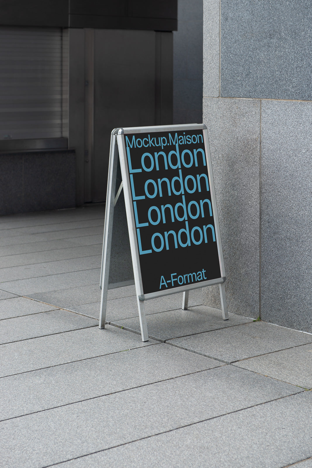 PSD mockup of an A-frame sidewalk sign with "London" text and gray urban environment, placed against a stone building facade.