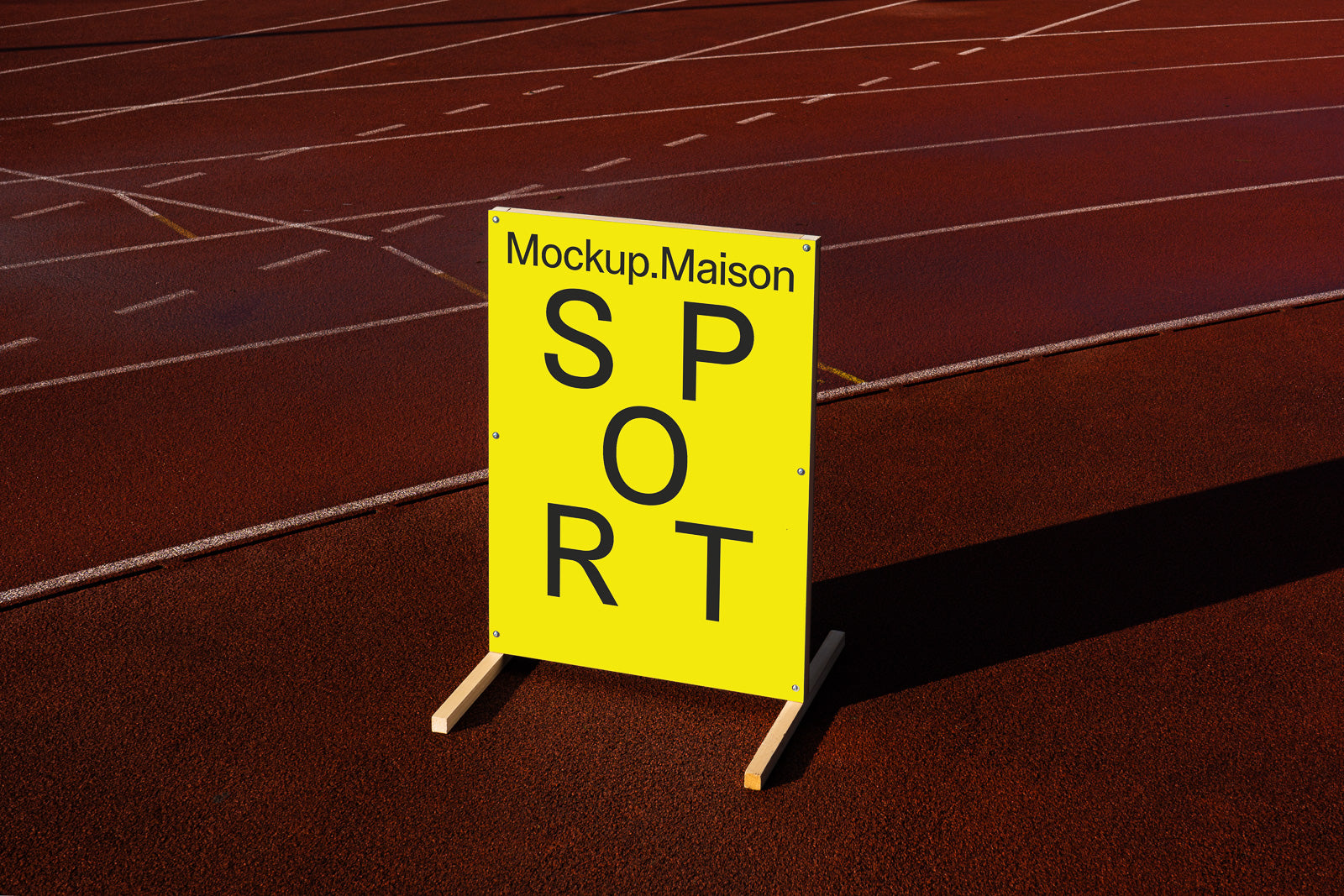 PSD mockup of a yellow sign with bold black letters spelling "SPORT" on a running track, casting a long shadow on the surface.