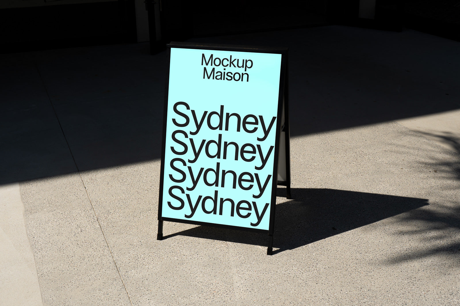 PSD mockup of a sandwich board with a light blue background displaying the word "Sydney" repeated in bold, black font and "Mockup Maison" at the top.