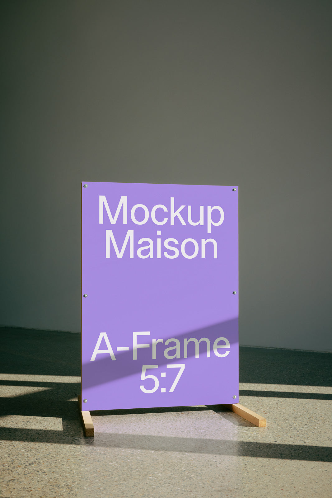 PSD mockup of a purple A-frame sign with text "Mockup Maison A-Frame 5:7" displayed on a wooden base against a neutral background.