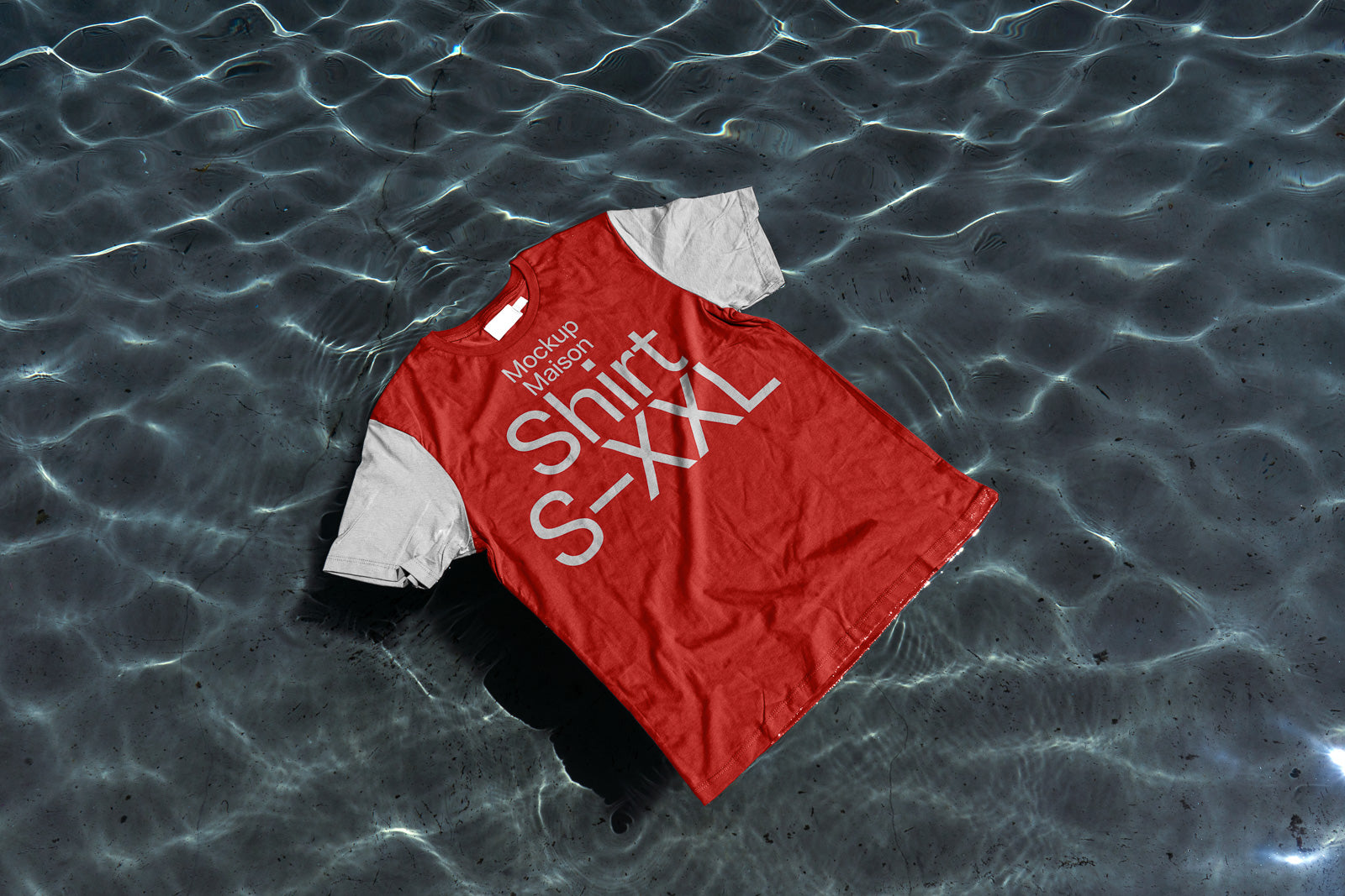 PSD mockup of a red T-shirt with gray sleeves floating on water, displaying the text "Mockup Maison Shirt S-XXL" across the front.