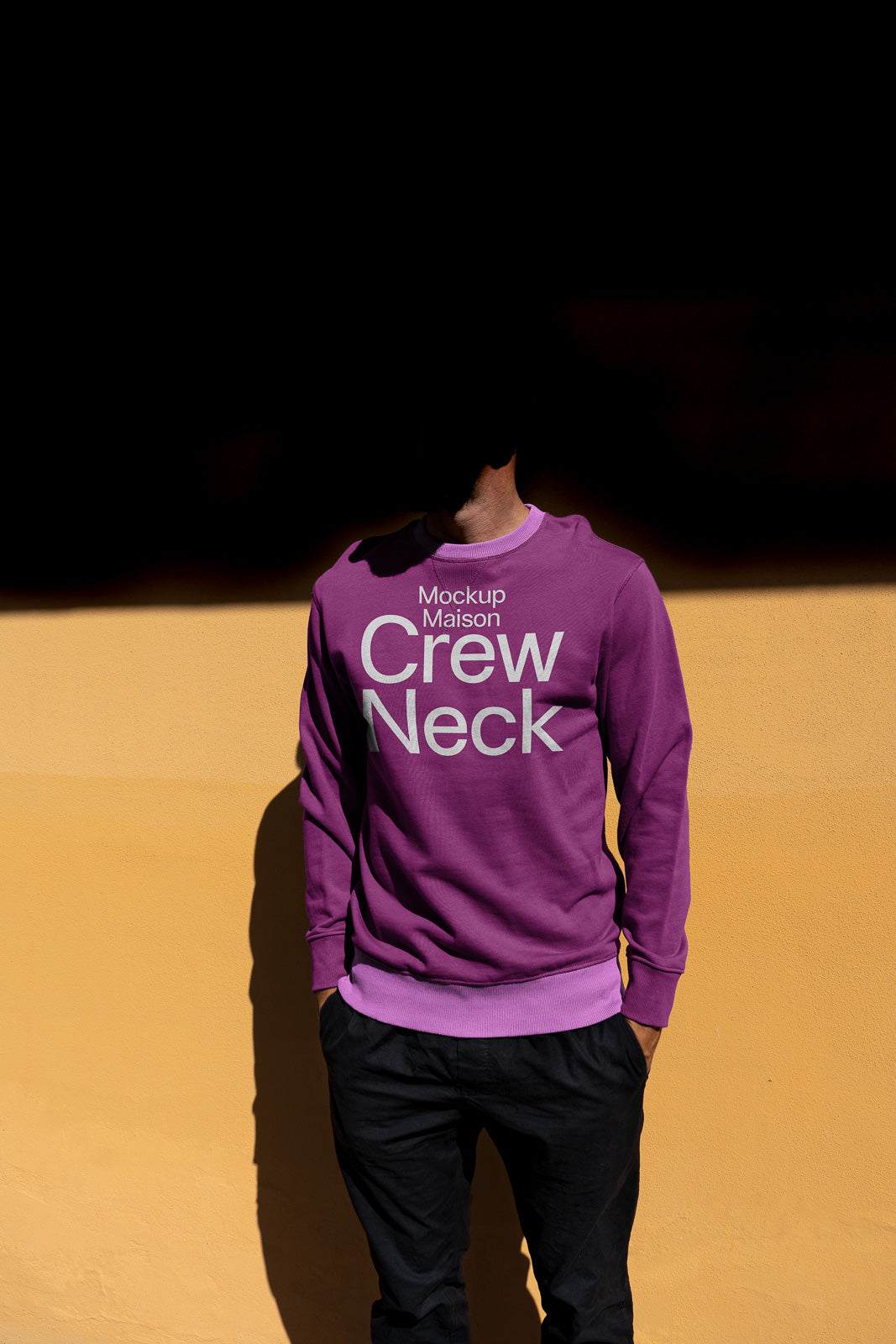 PSD mockup of a person wearing a purple crew neck sweatshirt with "Mockup Maison Crew Neck" text, standing against a yellow wall.