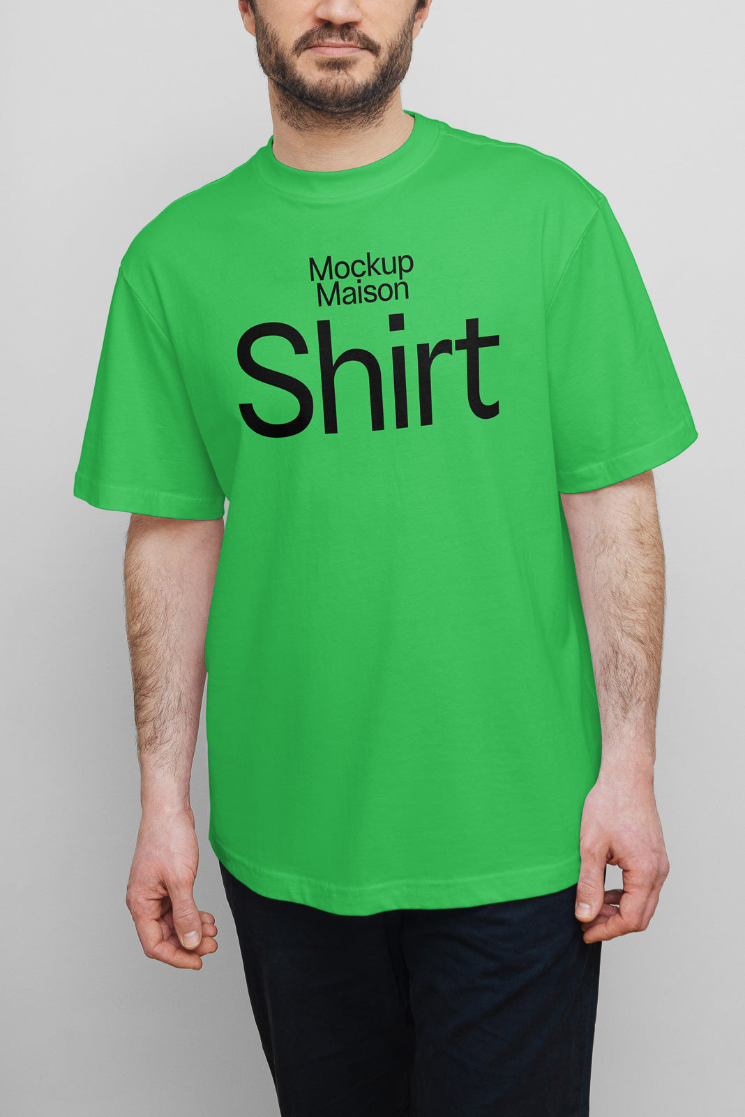 PSD mockup of a person wearing a bright green T-shirt with "Mockup Maison Shirt" in bold black lettering, showcasing casual apparel.