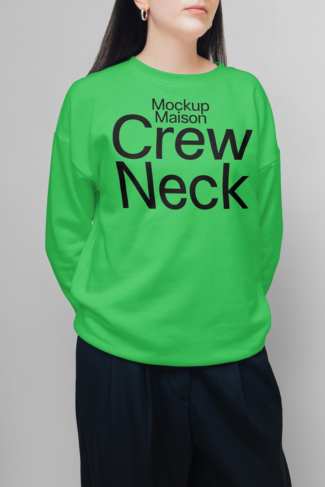 PSD mockup of a person wearing a vibrant green crew neck sweatshirt with "Mockup Maison Crew Neck" printed in bold, black letters.