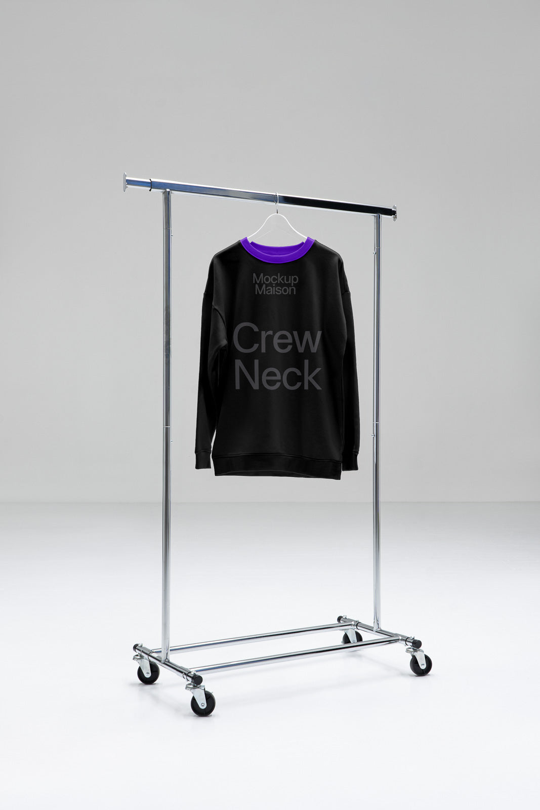 PSD mockup of a black crew neck sweater with purple collar hanging on a metal clothing rack in a minimalist setting.