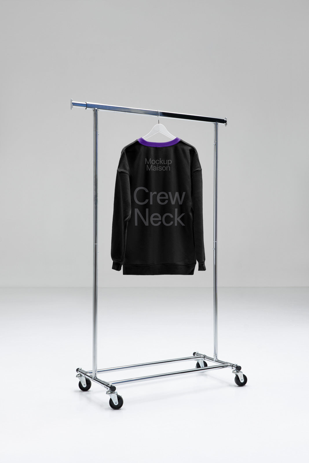PSD mockup of a black crew neck sweatshirt with purple collar hanging on a metal rack in a minimal studio setting.