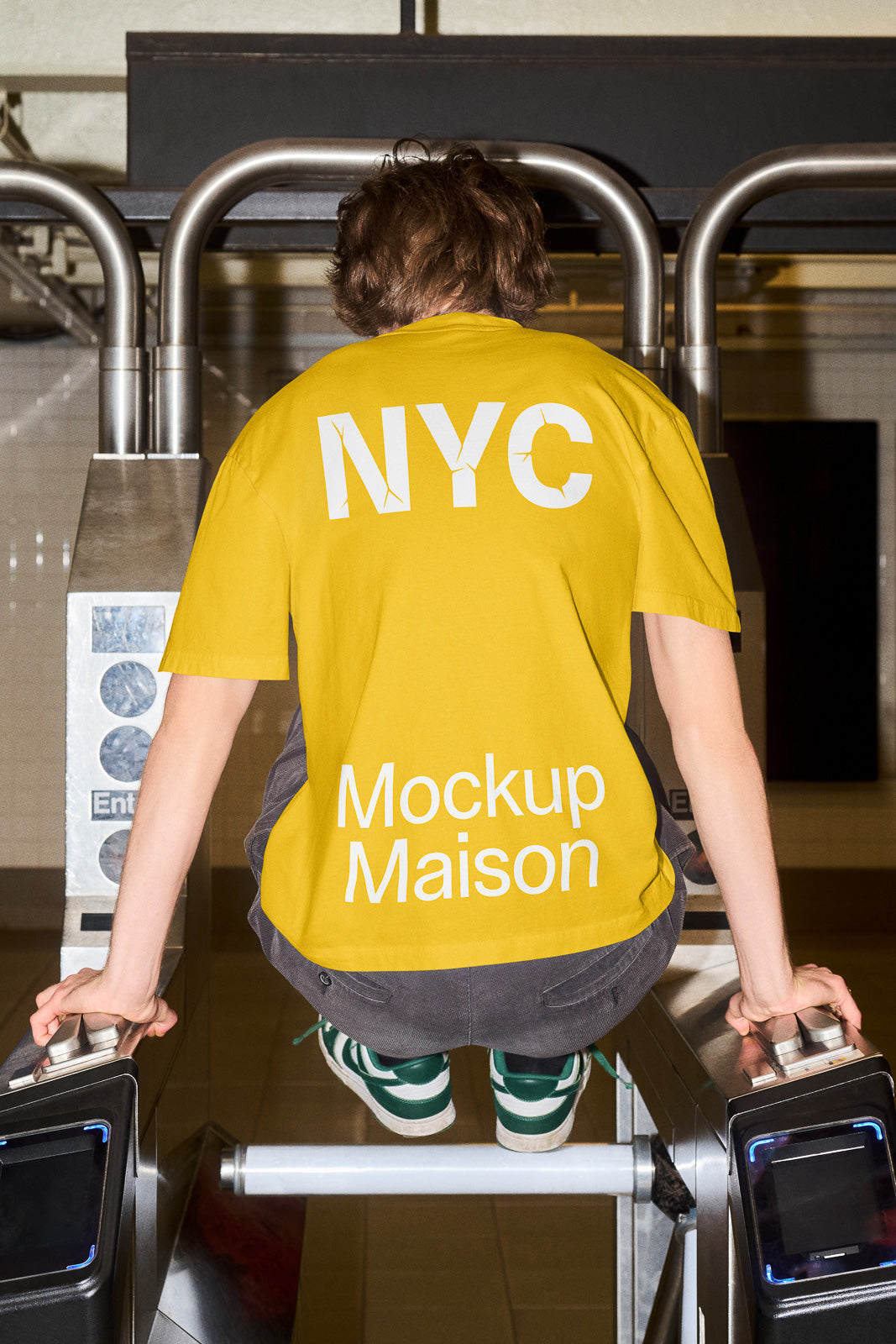 PSD mockup of a person in a yellow "NYC" and "Mockup Maison" shirt, sitting on a subway turnstile, highlighting urban style.