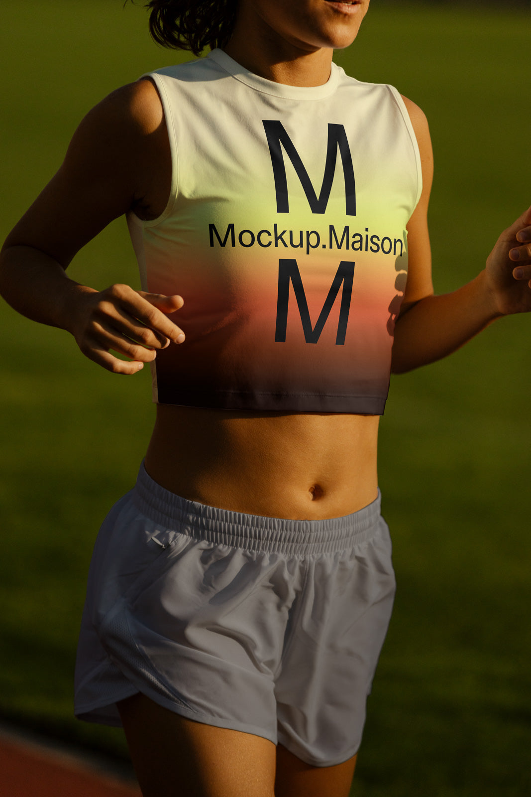 PSD mockup of a person jogging in a gradient-colored cropped workout top with "Mockup.Maison" text and matching shorts in a sunny outdoor setting.