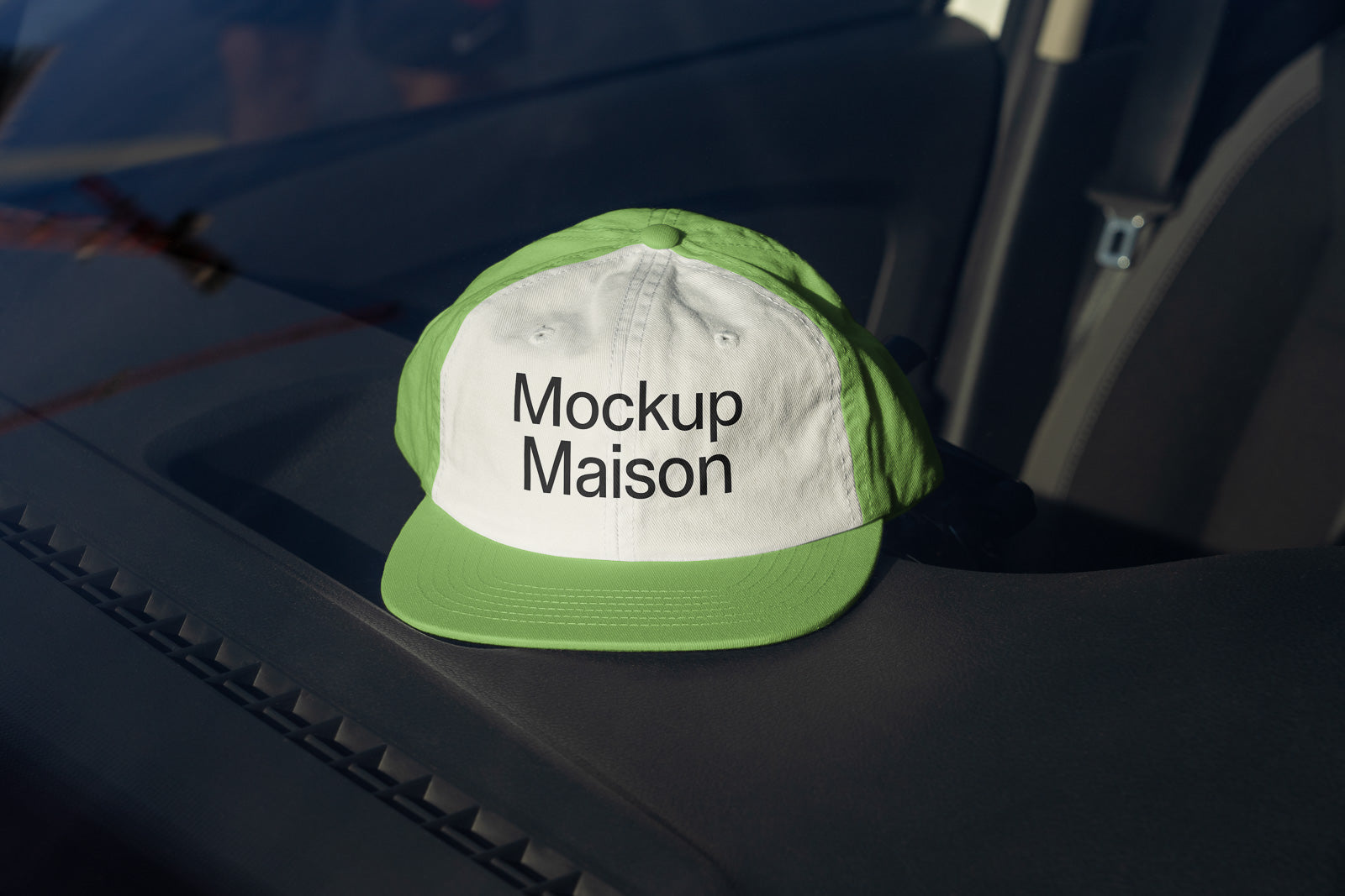 PSD mockup of a green and white baseball cap with the text "Mockup Maison" displayed on the dashboard of a vehicle.