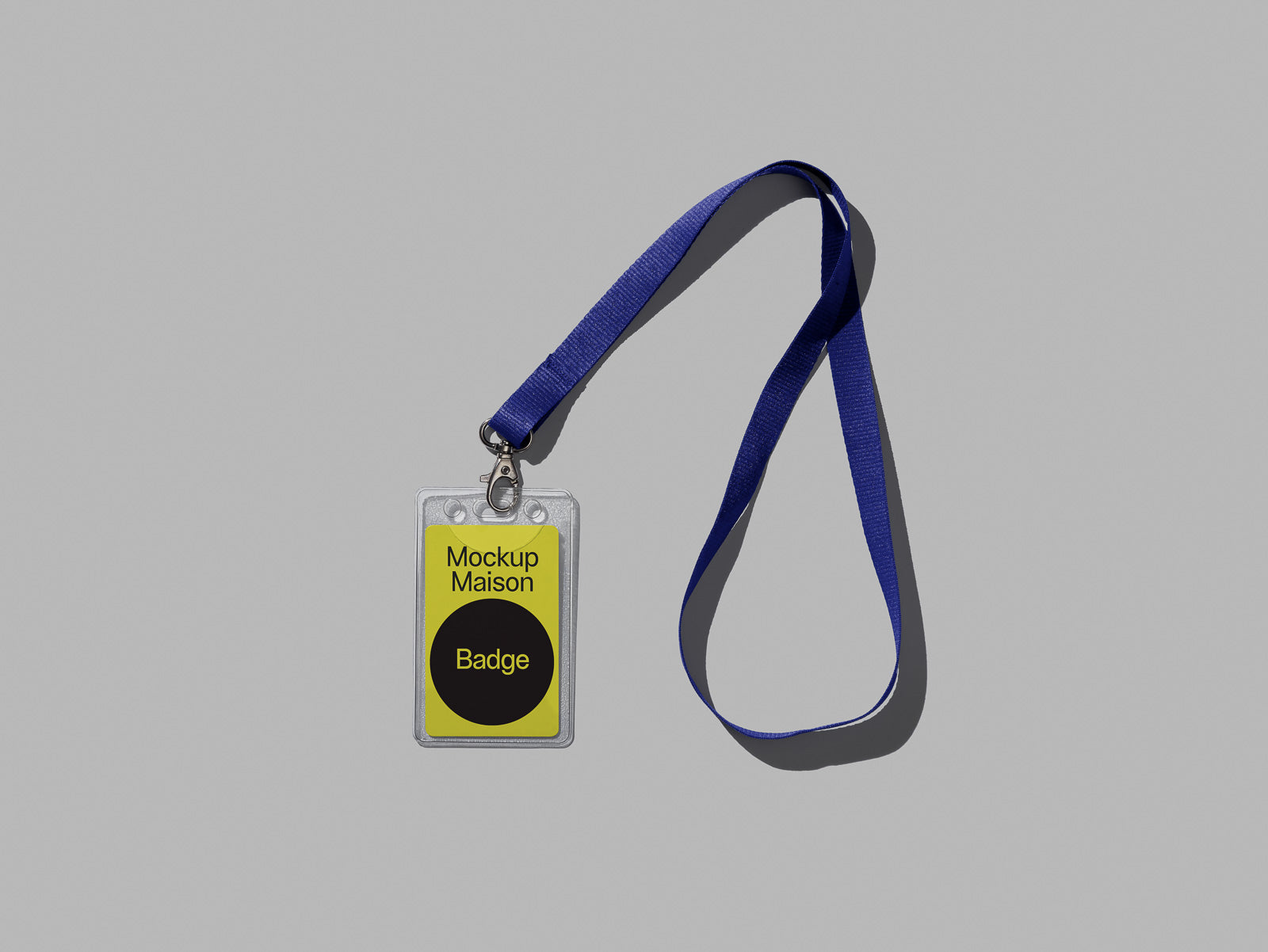 PSD mockup of a transparent badge holder with a blue lanyard on a gray background, featuring a yellow card labeled "Mockup Maison Badge."
