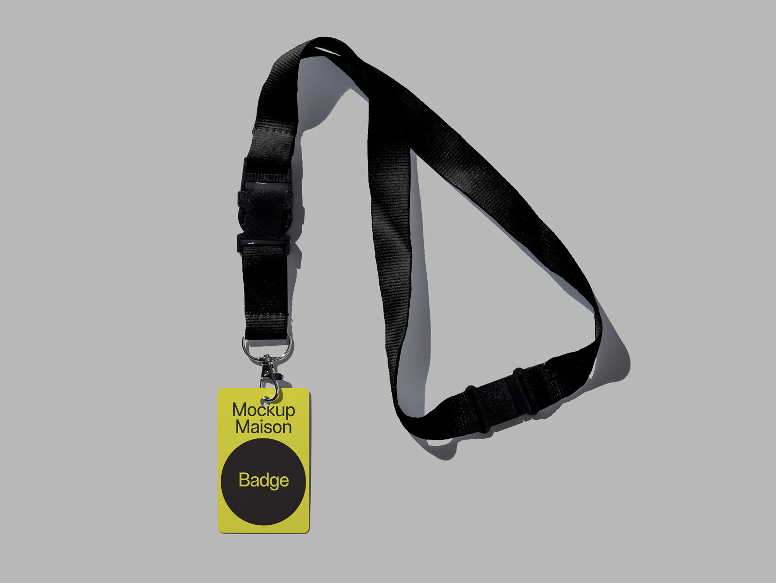 PSD mockup of a black lanyard with a yellow badge labeled "Mockup Maison Badge" on a gray background.