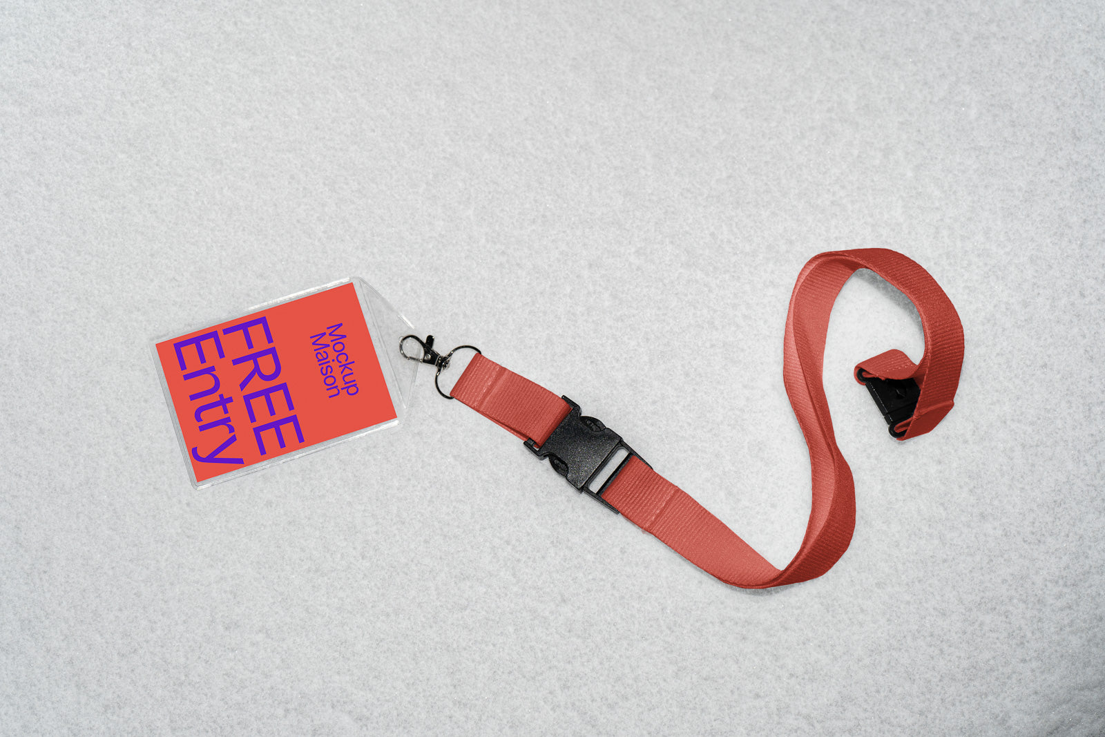 PSD mockup of a red lanyard with a black clasp attached to a plastic card holder displaying "Free Entry" on a light background.