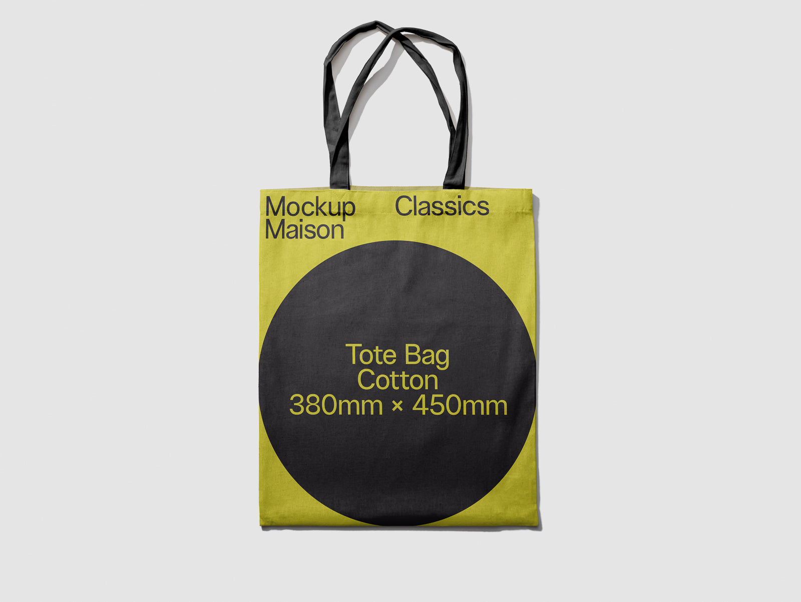 PSD mockup of a cotton tote bag with black handles and a green fabric design, featuring a large black circle displaying dimensions 380mm x 450mm.