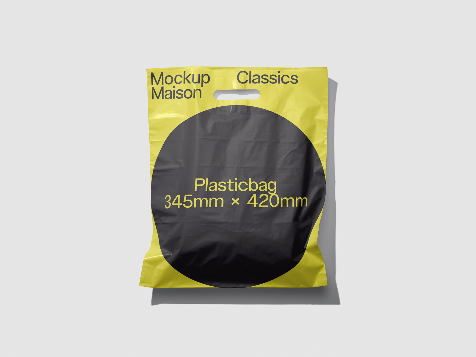 PSD mockup of a yellow and black plastic bag with "Mockup Maison Classics" text and dimensions 345mm x 420mm printed on it.