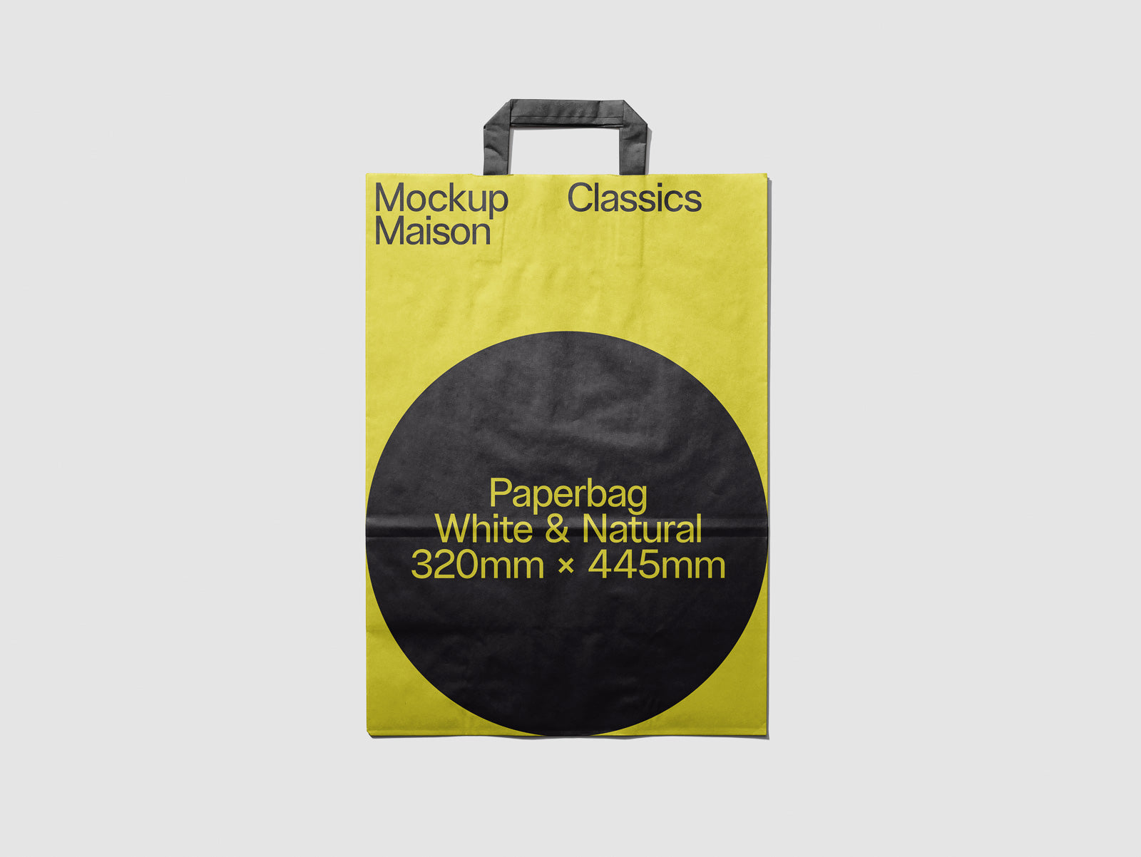 PSD mockup of a yellow and black paper bag displaying text: "Mockup Maison Classics" and "Paperbag White & Natural 320mm x 445mm" with a handle on top.