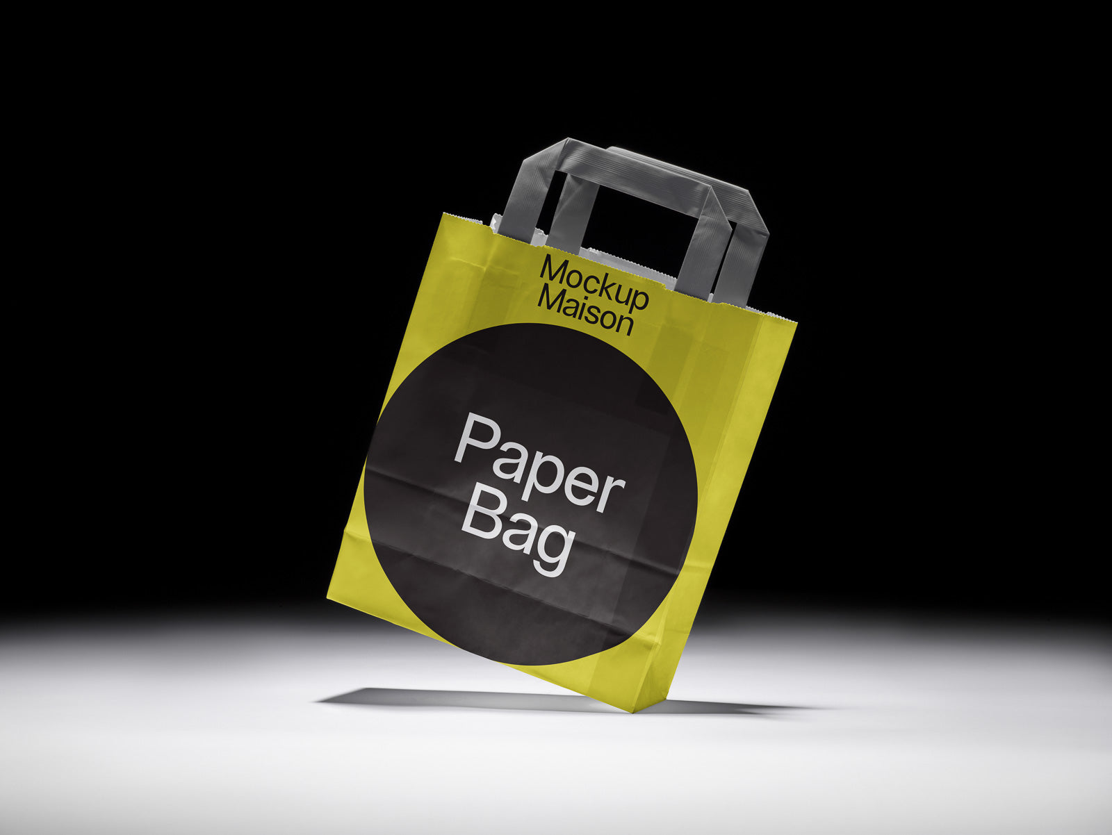 PSD mockup of a yellow paper bag with black handles and a large black circle on the front displaying the text "Paper Bag."