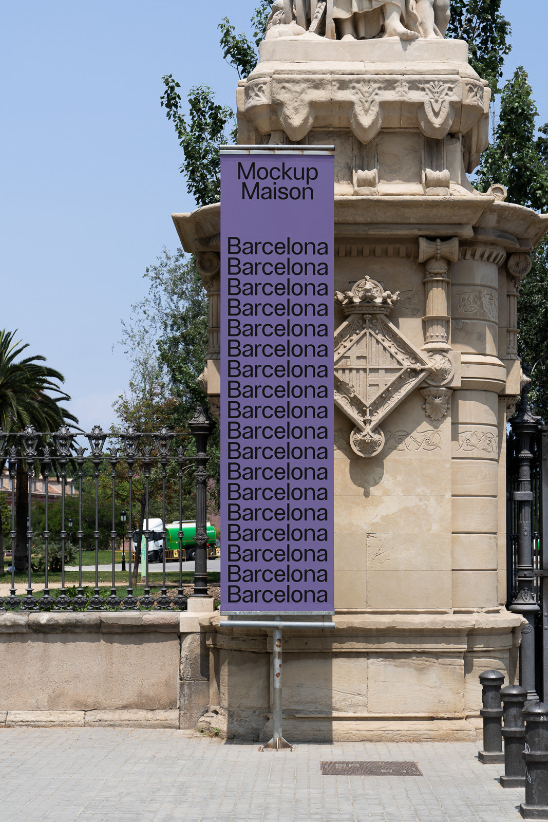 PSD mockup of a vertical banner attached to a stone structure outdoors, with "Mockup Maison" and "Barcelona" text on a purple background.