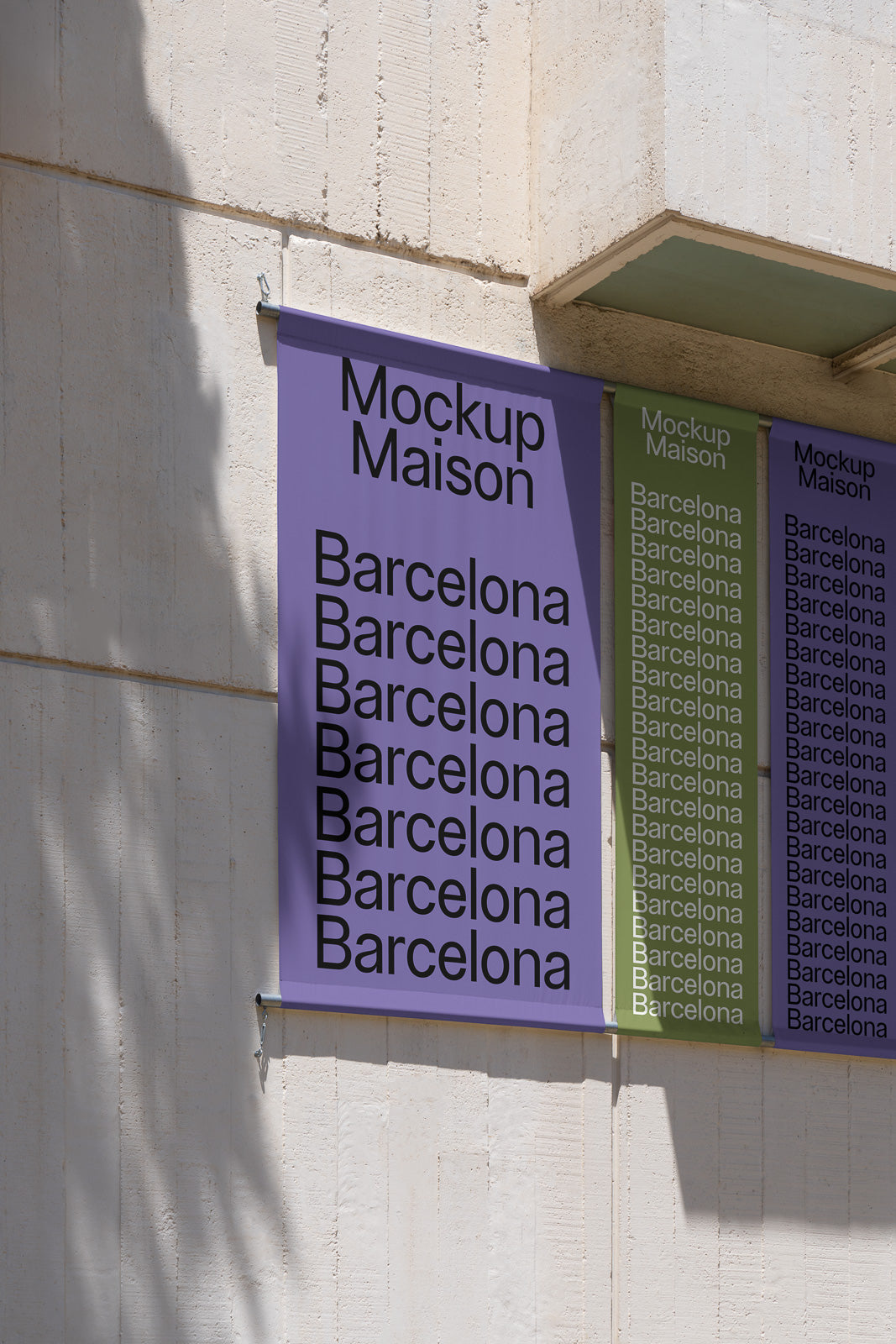 PSD mockup of colorful wall-mounted banners with the text "Mockup Maison Barcelona" repeated. Banners in shades of purple and green against a textured wall.