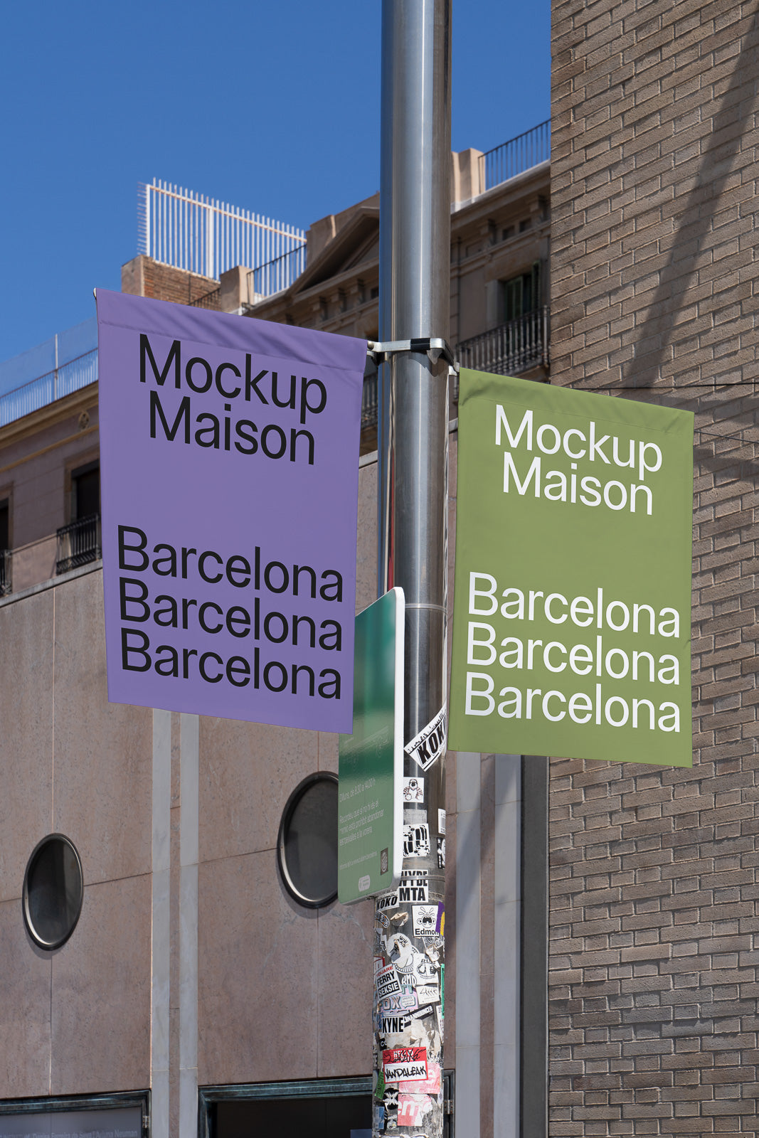 PSD mockup of two vertical banners on a pole in an urban setting, featuring "Mockup Maison" and "Barcelona" text, with a building in the background.