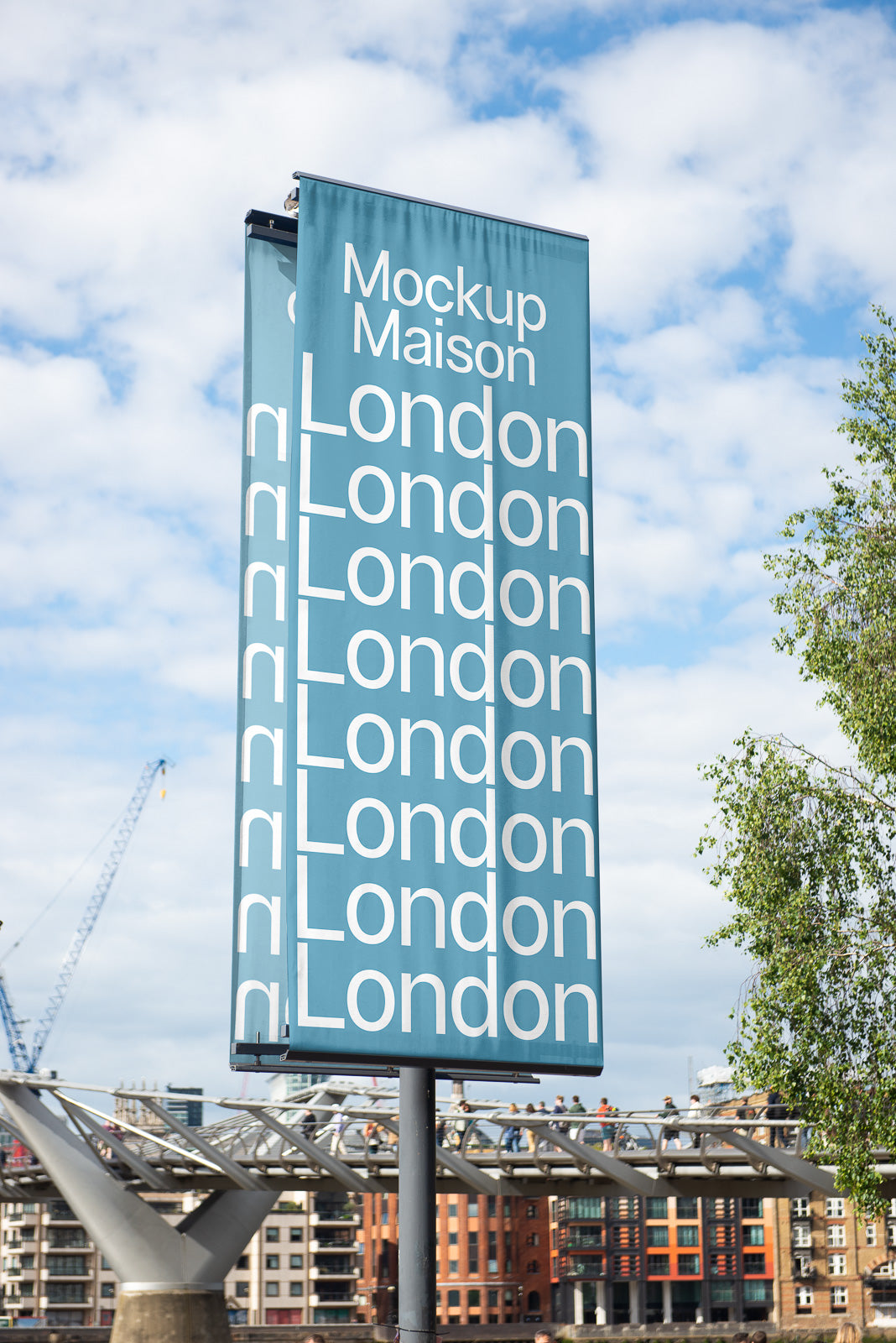 PSD mockup of a tall blue sign featuring repeated white text "London" with urban buildings and clear sky in the background.