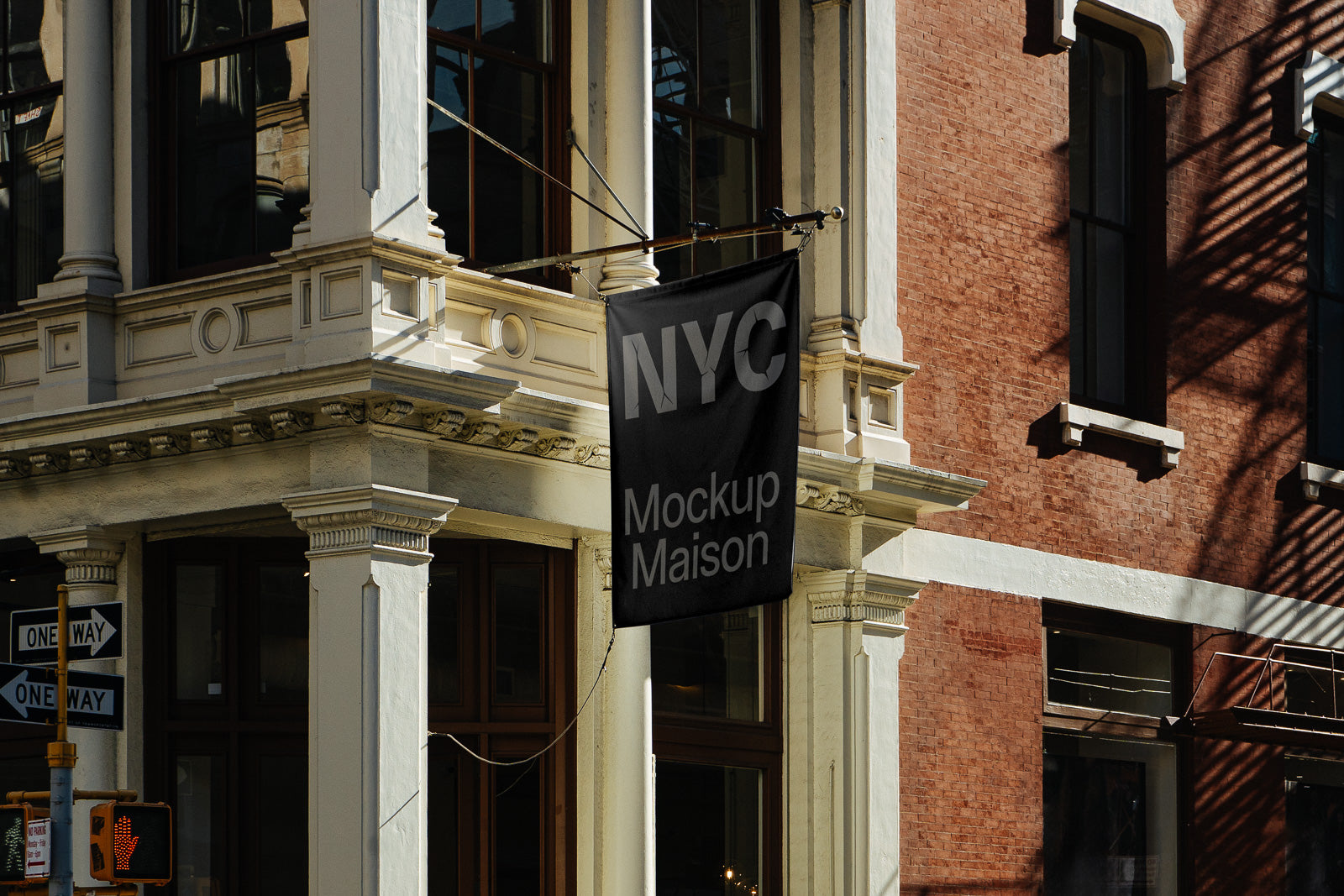 PSD mockup of a black hanging banner on an urban building corner, featuring the text "NYC Mockup Maison" with architectural details and street signs.