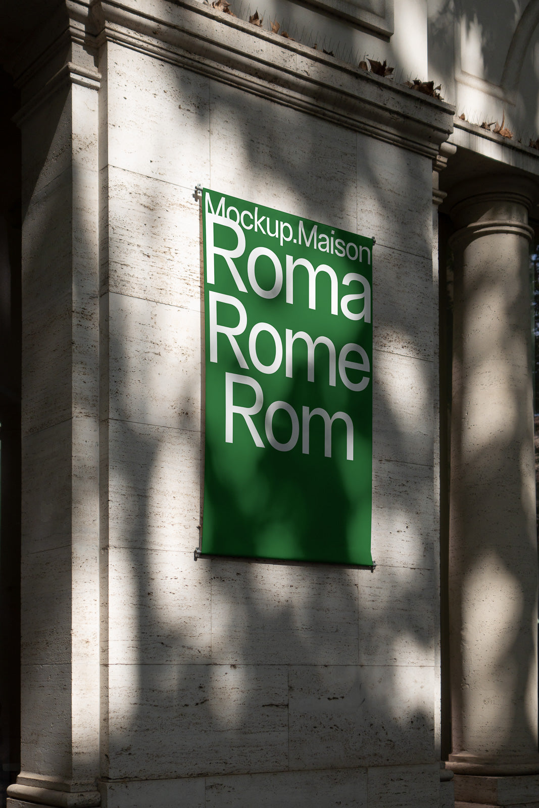 PSD mockup of a green vertical banner reading "Mockup.Maison Roma Rome Rom" hanging on a stone building wall, casting shadows.