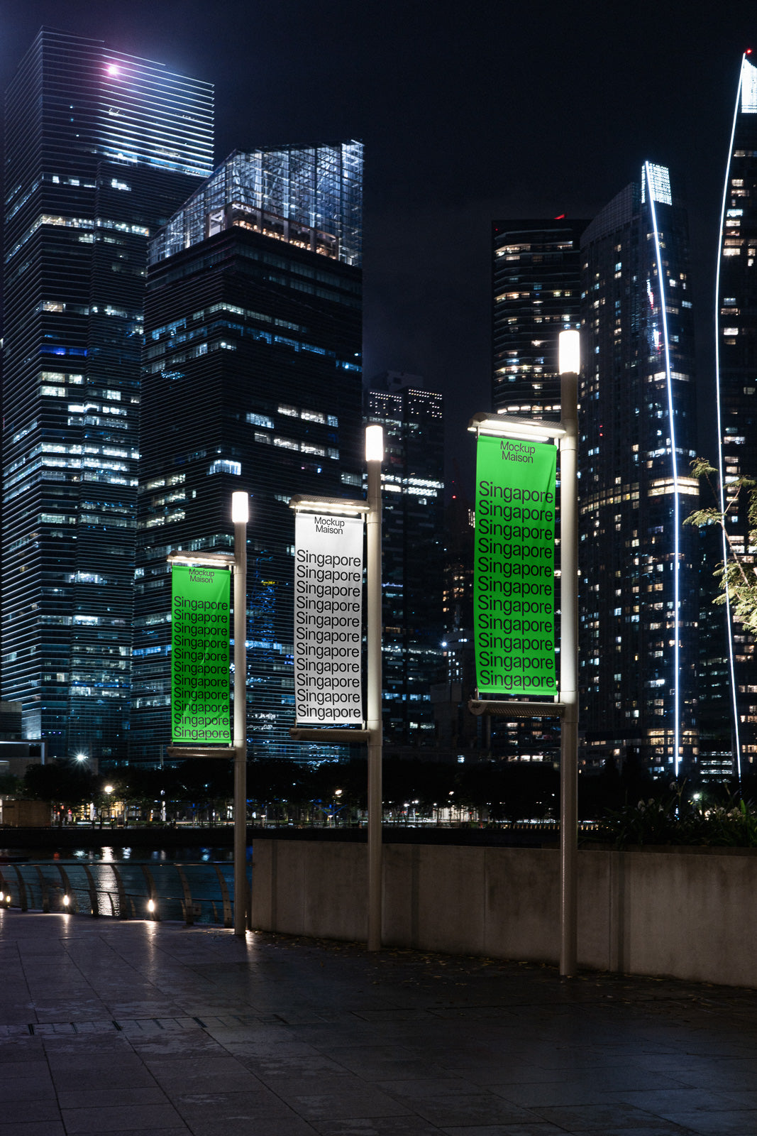 PSD mockup of illuminated street banners displaying "Singapore" repeatedly at night, set against a backdrop of modern skyscrapers with city lights.