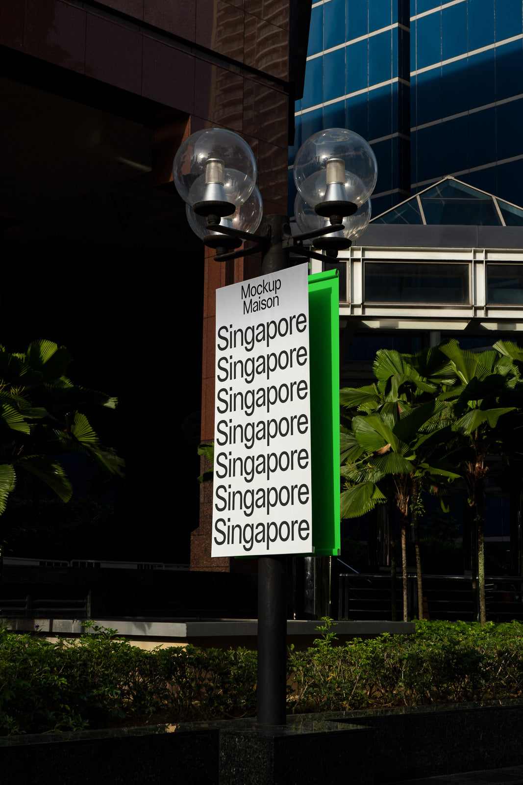 PSD mockup of a vertical street sign with multiple "Singapore" text in bold letters, set against a backdrop of urban greenery and buildings.