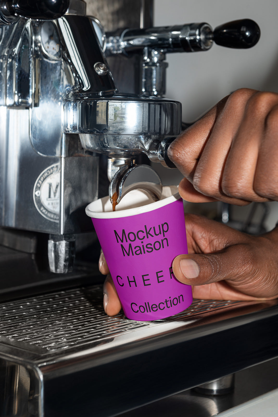 PSD mockup of a vibrant purple coffee cup labeled "Mockup Maison CHEER Collection" held under an espresso machine brewing coffee.