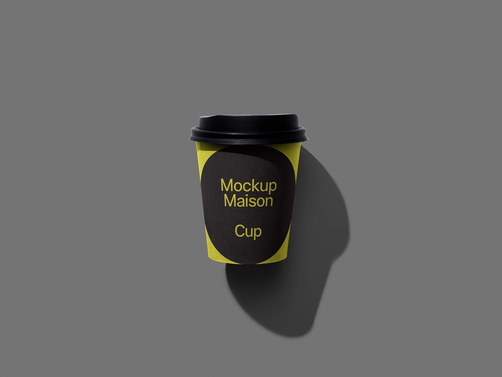 PSD mockup of a coffee cup with a black lid on a gray background, featuring bold yellow and black graphics labeled "Mockup Maison Cup."