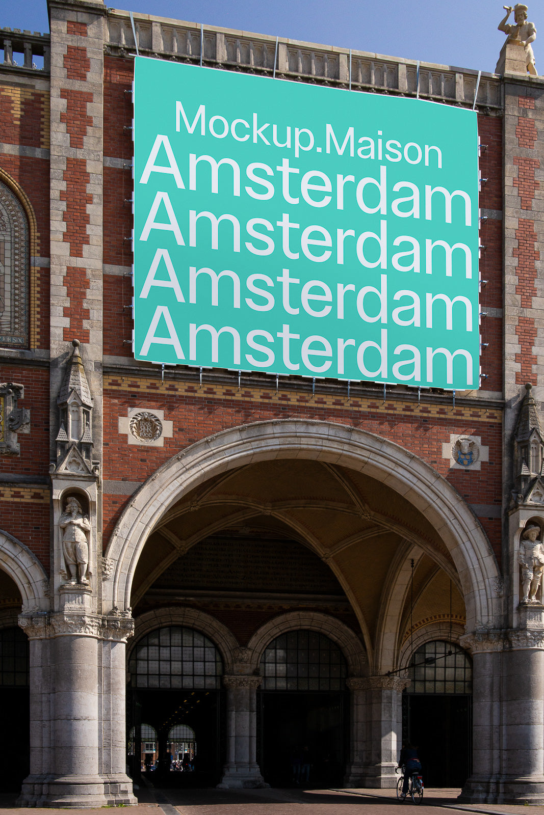 PSD mockup of a large turquoise banner with white text displaying "Amsterdam" multiple times, attached to a historic building facade.