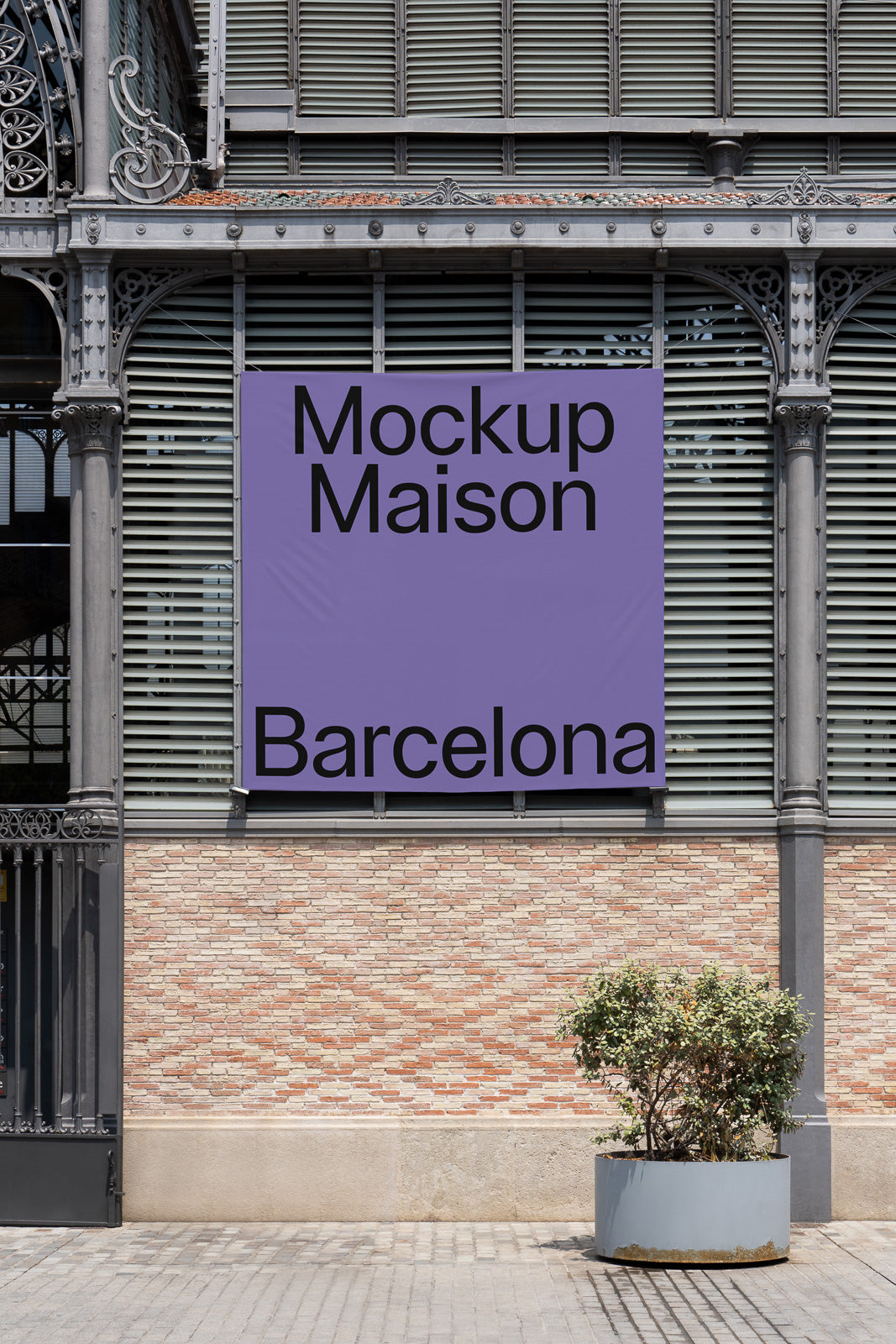 PSD mockup of a purple banner reading "Mockup Maison Barcelona" displayed on a building with brick and metal architecture, surrounded by a modern urban setting.