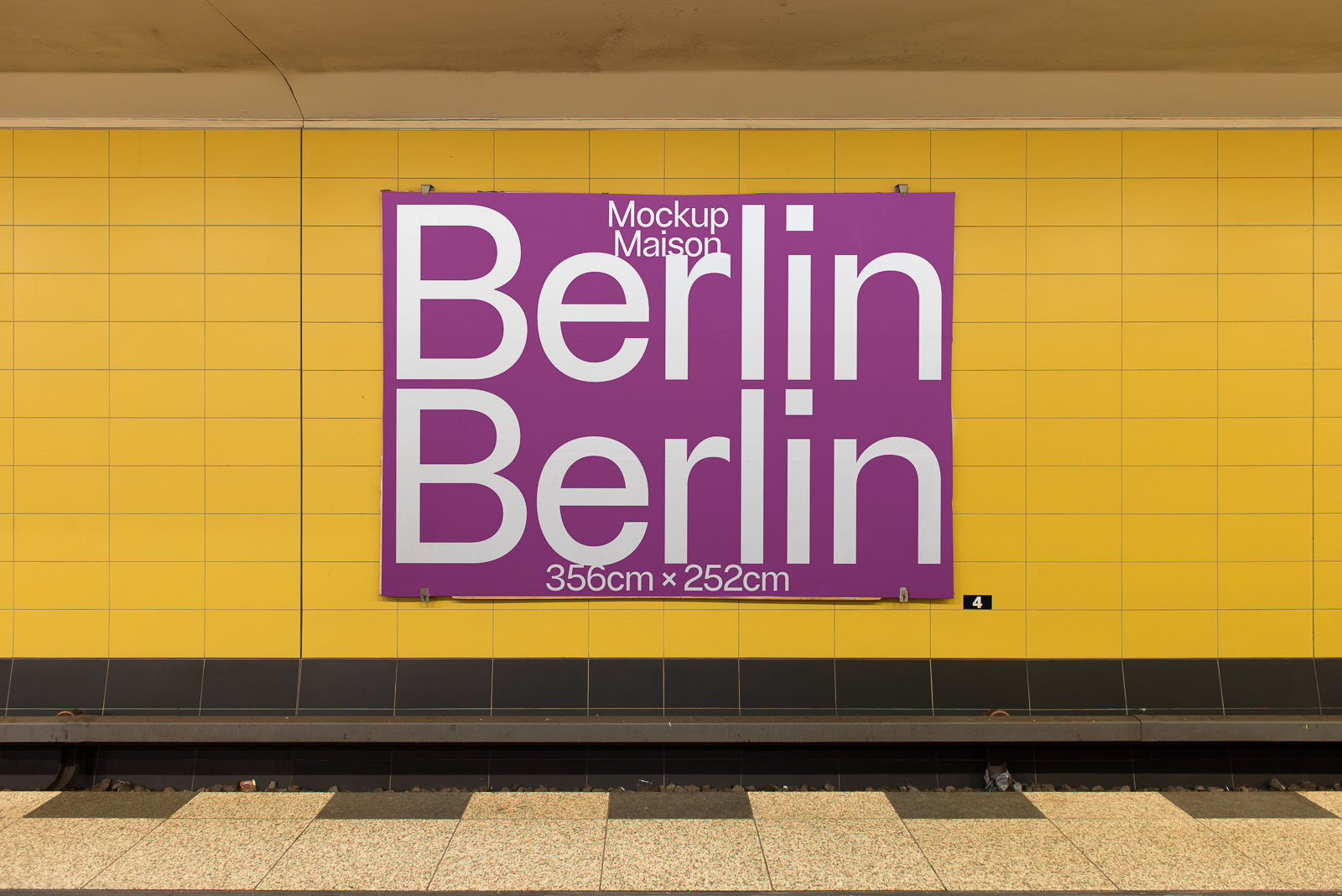 PSD mockup of a large purple poster displaying the word "Berlin" placed on a yellow tiled wall in a subway station, measuring 356cm by 252cm.