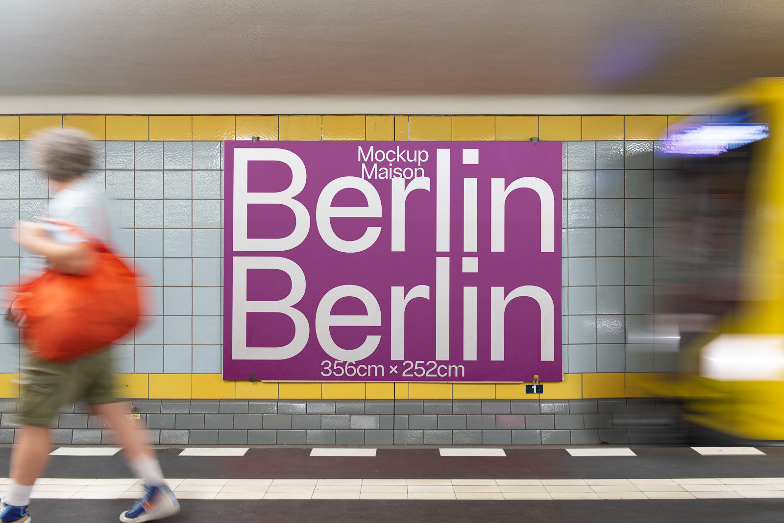 PSD mockup of a subway station wall poster in Berlin, featuring bold white text on a purple background. A person with an orange bag walks by.