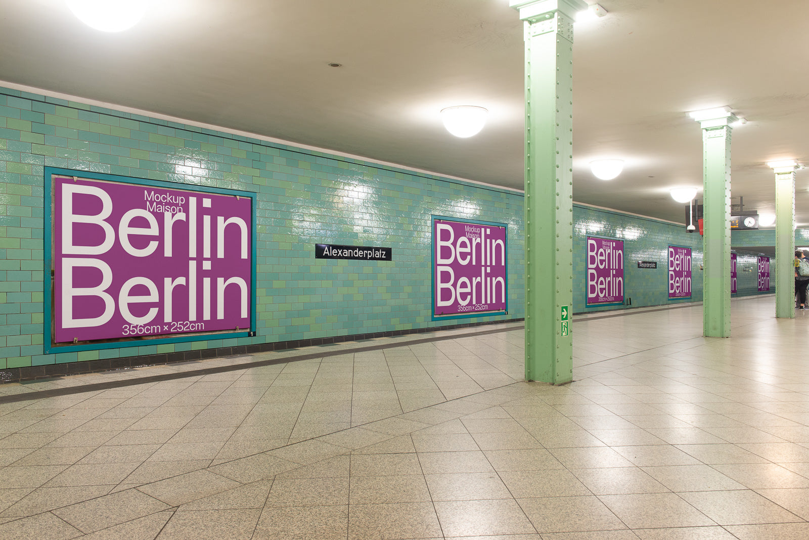 PSD mockup of multiple large posters in a subway station with green-tiled walls and signs reading "Alexanderplatz," highlighting the Berlin-themed design.