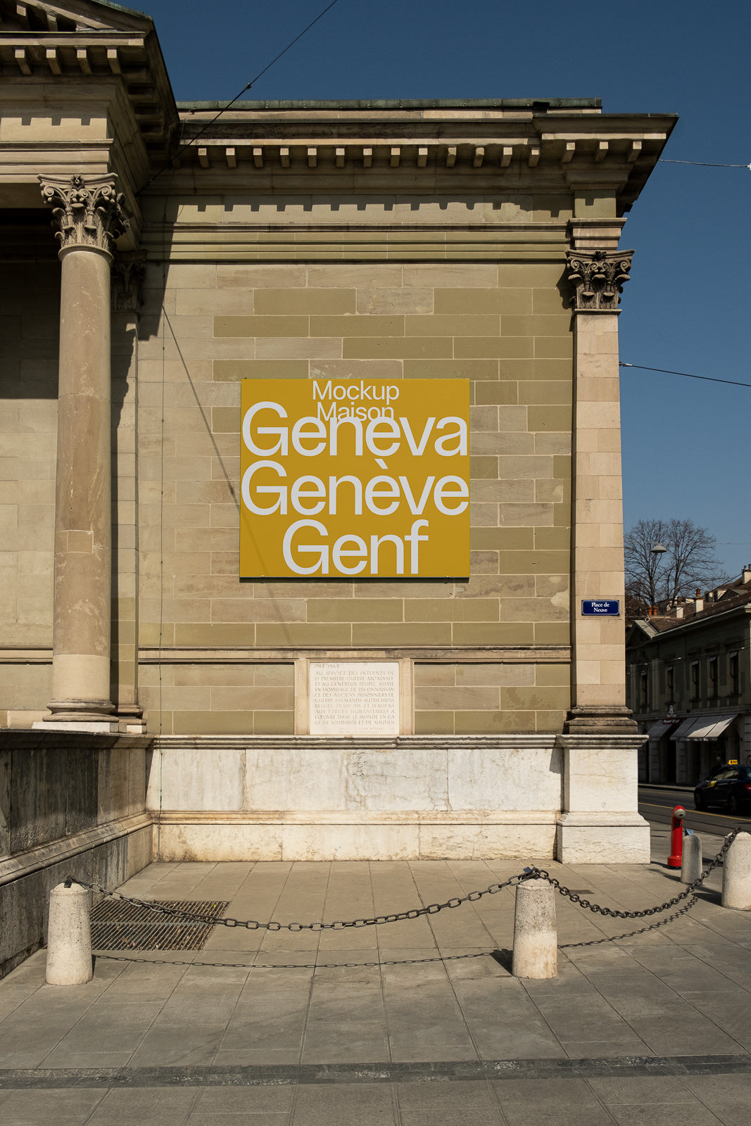 PSD mockup of a building facade with a large yellow sign displaying "Geneva, Genève, Genf" in bold white letters. The structure has classic architectural elements.