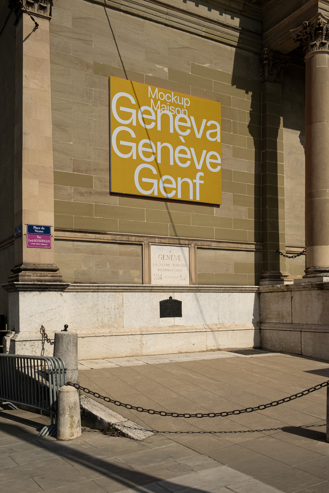 PSD mockup of a yellow wall sign displaying the words "Geneva Genève Genf" in white letters, mounted on a stone building facade.
