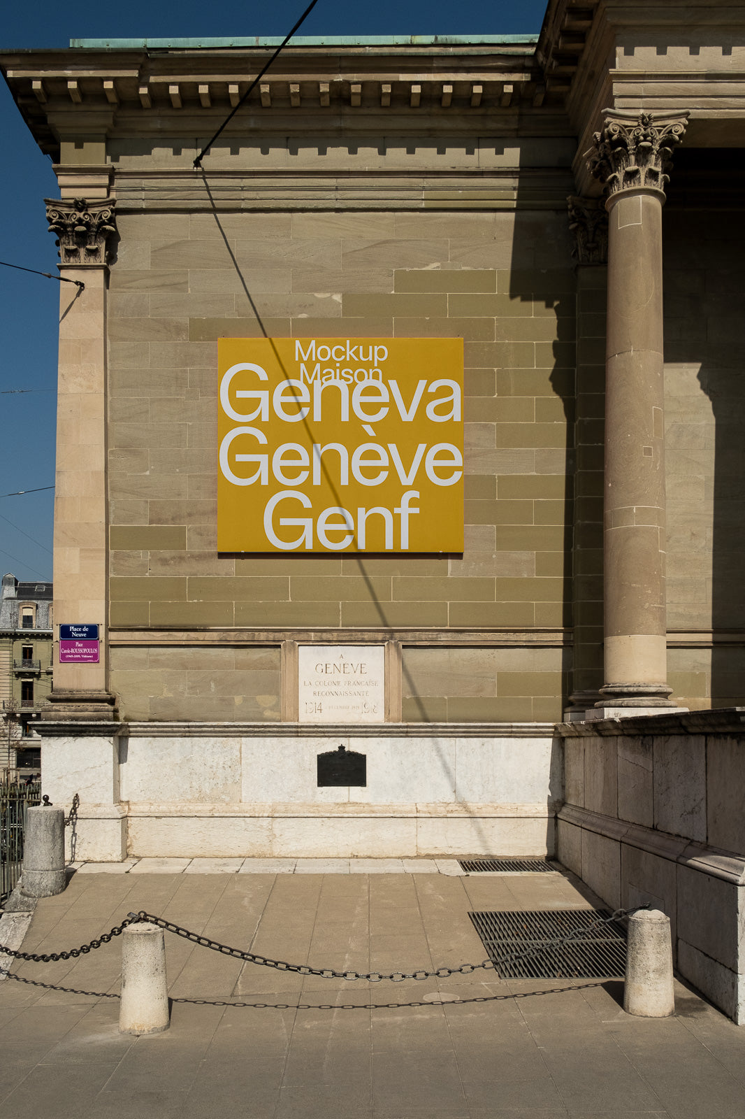 PSD mockup of a large yellow sign on a classical building facade, featuring text "Geneva, Genève, Genf" in white letters.
