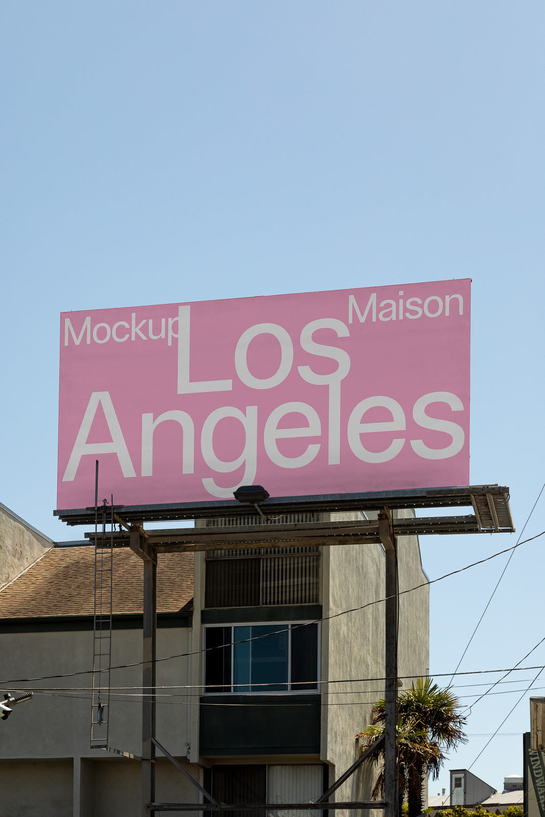 PSD mockup of a large pink billboard displaying the words "Los Angeles" in bold white letters with a clear blue sky background.