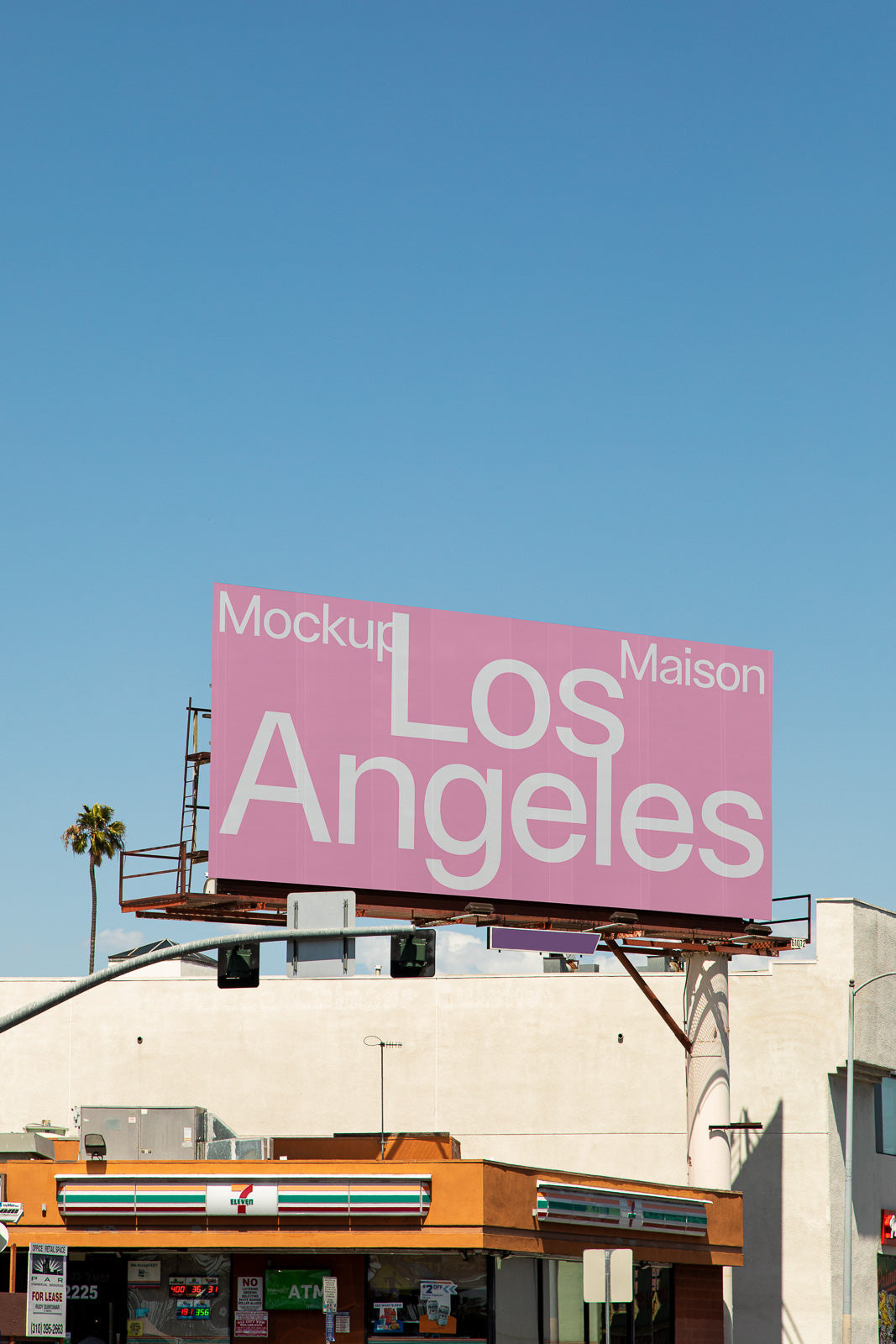 PSD mockup of a large billboard in an urban setting displaying "Los Angeles" with pink background and white text, clear sky backdrop.
