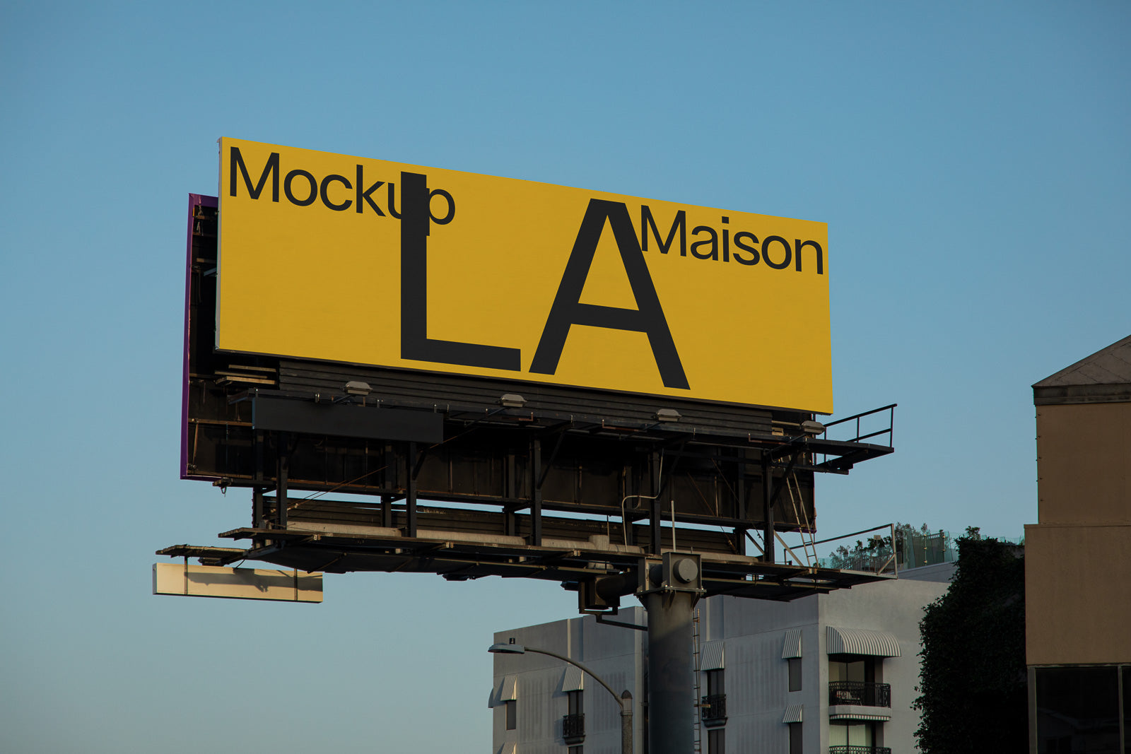 PSD mockup of a large yellow billboard with text "Mockup LA Maison" against a clear blue sky, mounted on a metal structure.