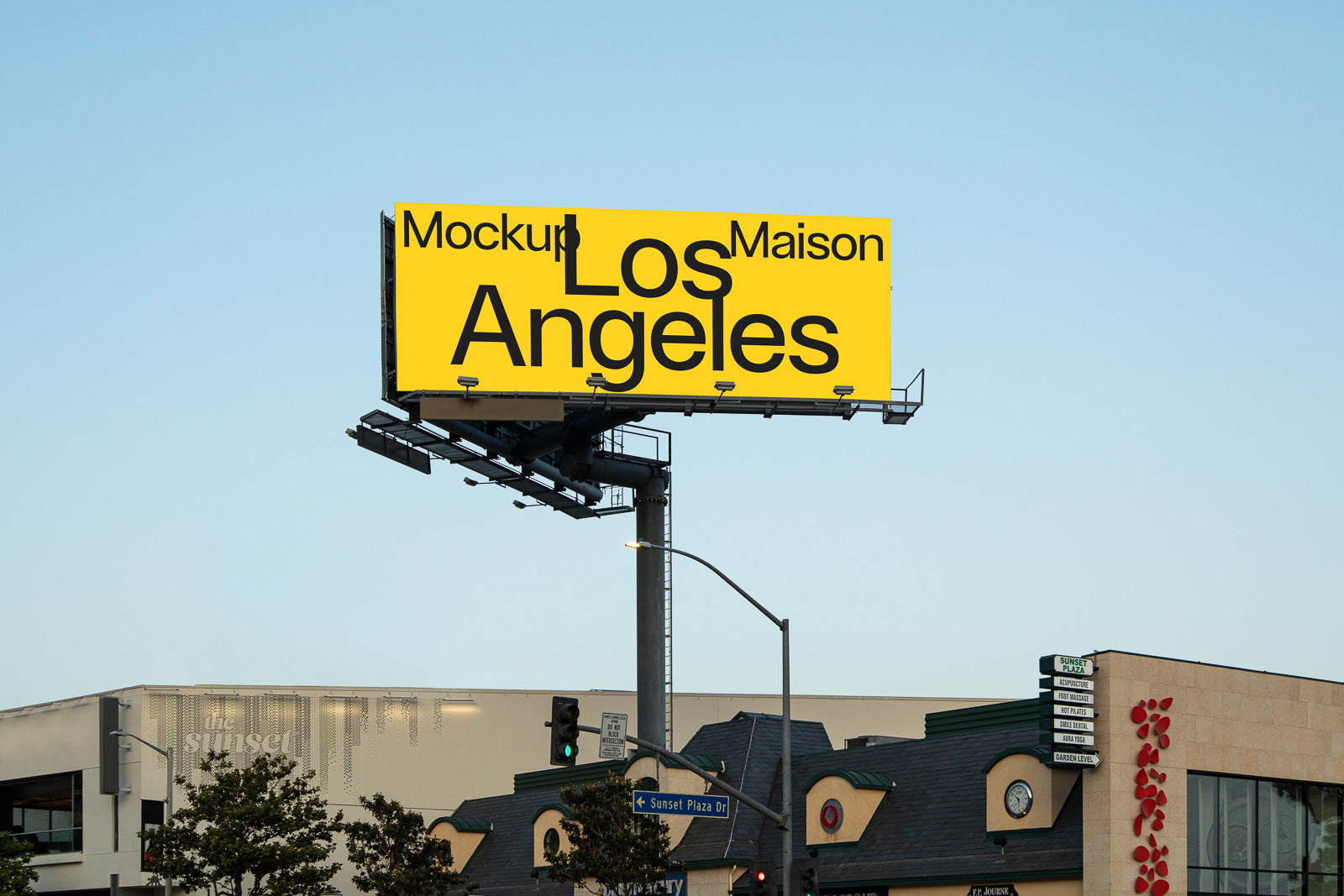 PSD mockup of a large yellow billboard displaying the words "Mockup Maison Los Angeles" in black text, positioned above a street intersection.