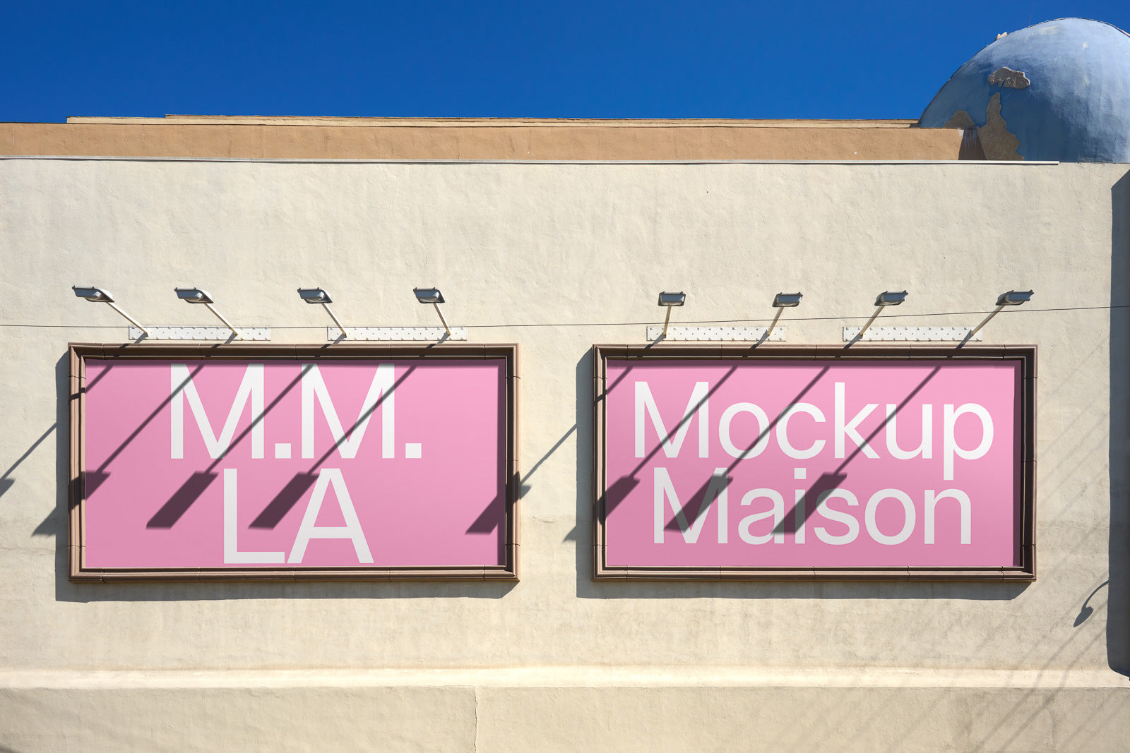 PSD mockup of two pink billboards on a beige wall with blue sky background, displaying white text reading "M.M. LA" and "Mockup Maison."
