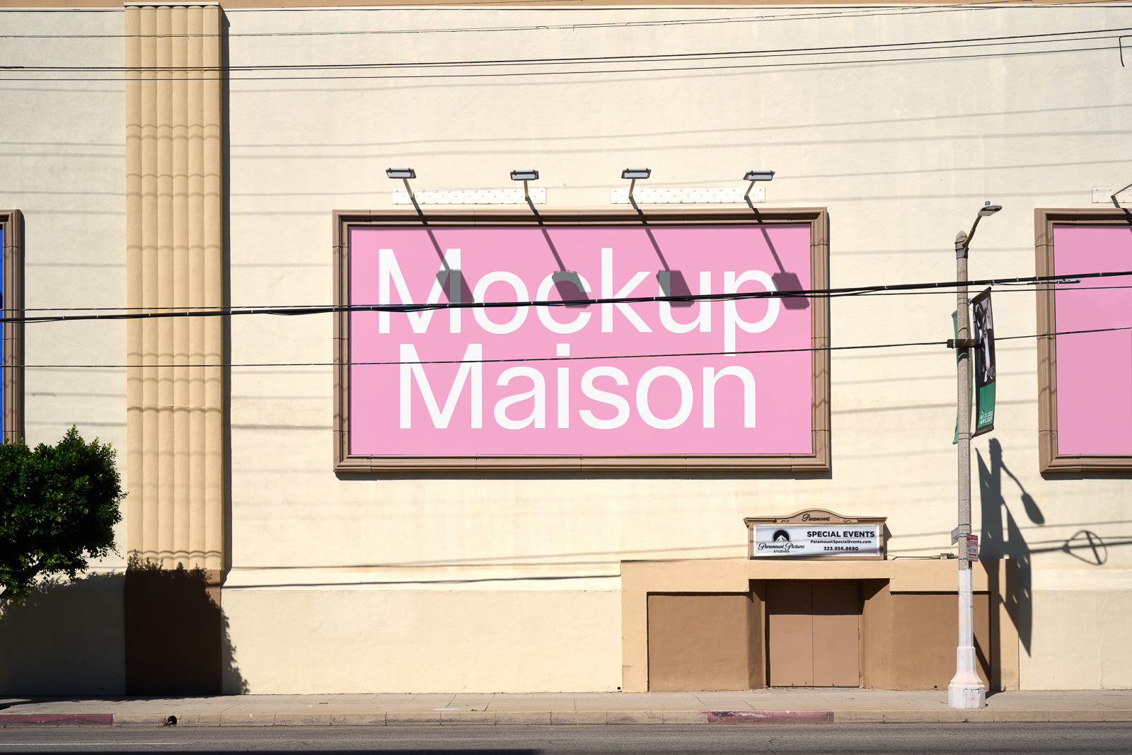 PSD mockup of a large pink billboard mounted on a beige building facade, featuring the text "Mockup Maison" in large white font.