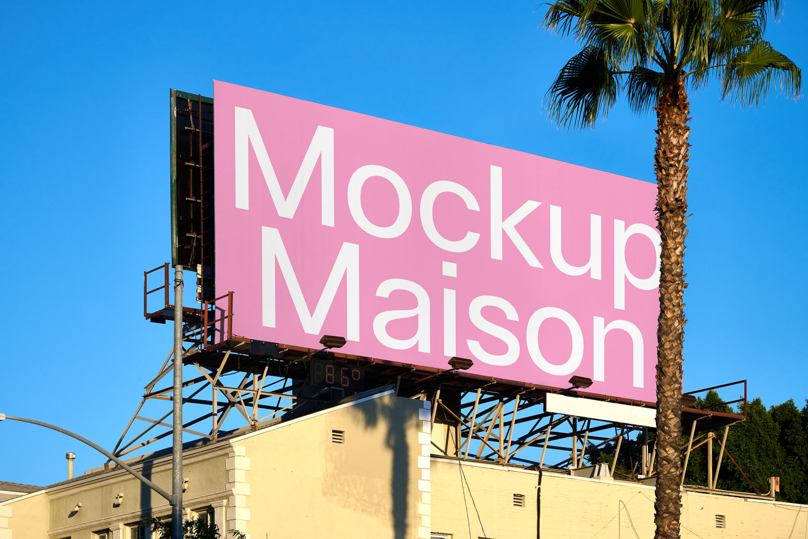 PSD mockup of a large outdoor billboard with a pink background and white text, set against a clear blue sky, adjacent to a palm tree.