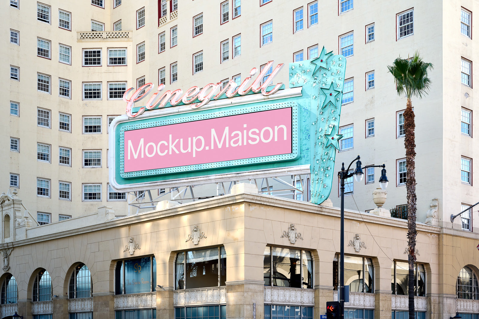 PSD mockup of a retro-style cinema marquee displaying "Mockup.Maison" against a backdrop of a large beige building with multiple windows.