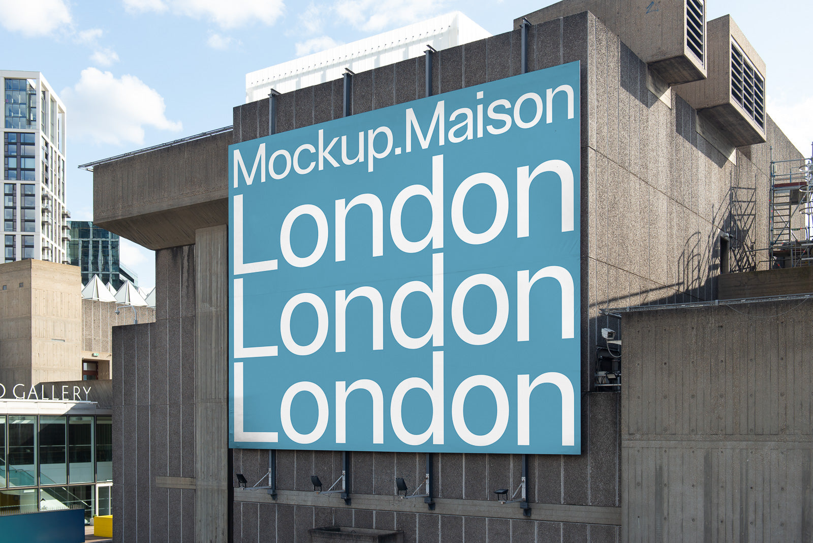 PSD mockup of a large blue billboard on a building, displaying the text "Mockup.Maison London" in white, with an urban background.
