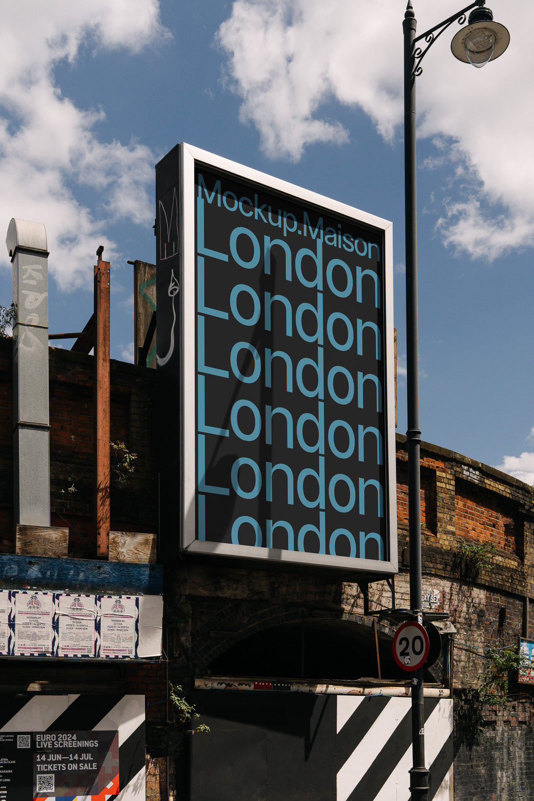 PSD mockup of a roadside billboard displaying repeated blue text "London" against a black background with urban setting under a bright sky.